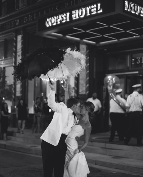 What I love about weddings in New Orleans is the traditions. The second line experience is so magical and fun and a photographer's gold mind! Paige and Parker were lead by The Wise Guys from ceremony to celebration and this image was captured by Caitlyn B Photography .