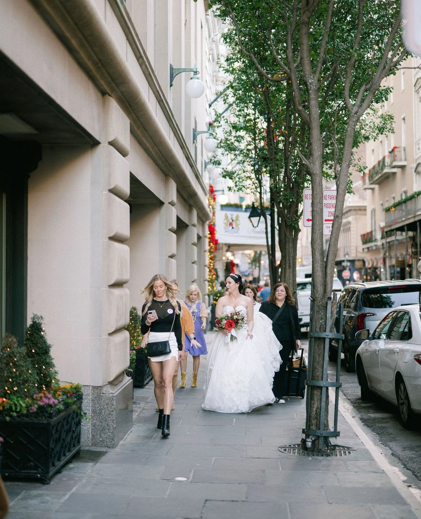 Strolling down the sidewalk, train in hand, shaping the cake moment, and orienting the first look. Sydney and Patrick let me do the work so they could enjoy the day, and we were all better off for it! ⁠
⁠
Ceremony - Reception: @hotelmonteleone⁠
Weddi