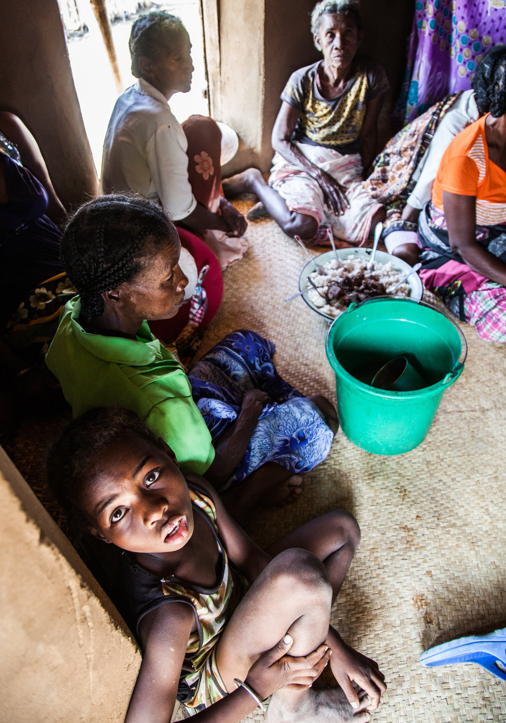  The small hut is filled with the boy's family who eat a final meal in his presence 