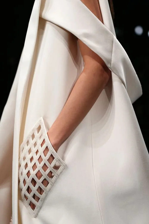 I'm imagining how attention grabbing these pockets would be if you were to wear them in the real world and not on a runway. Definitely intriguing, although I would worry for my lip gloss that it might not stay inside. Dress by Balenciaga. 