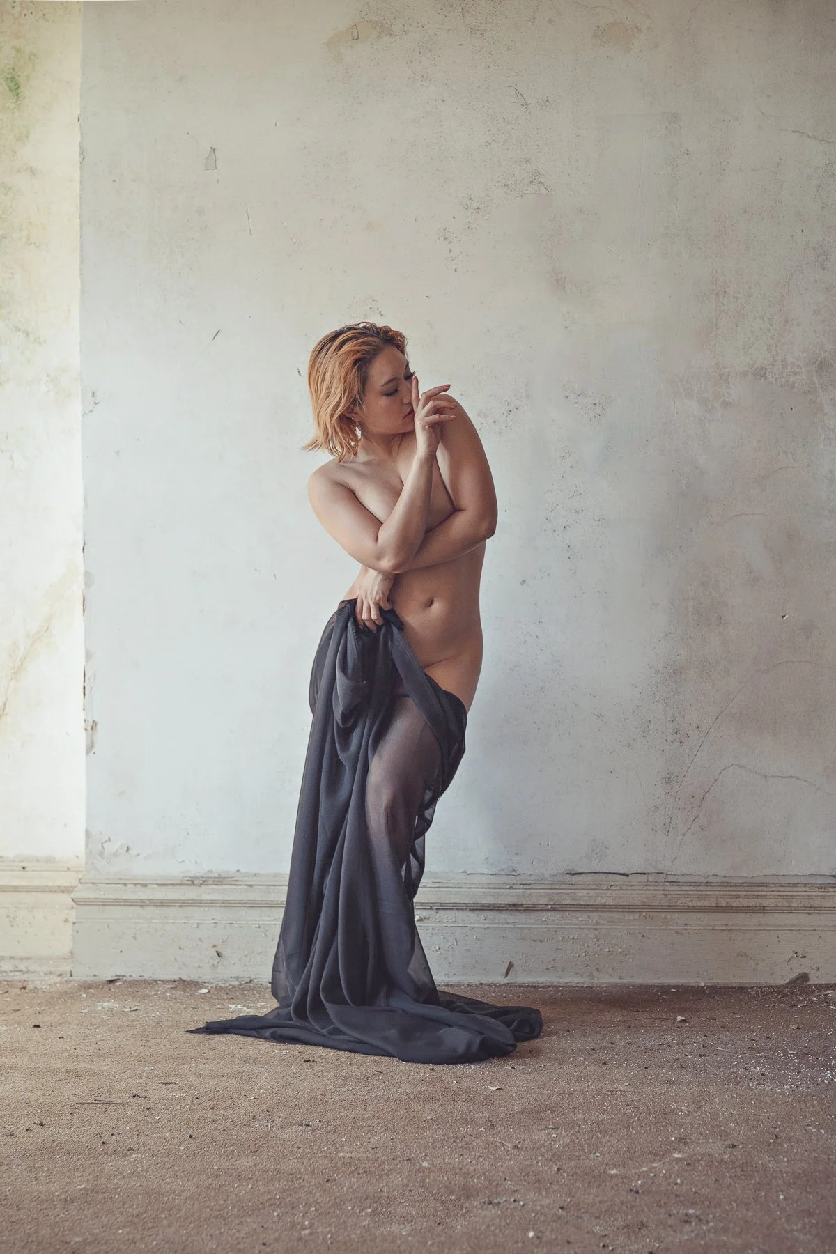 nude model with draped cloth in an abandoned mansion
