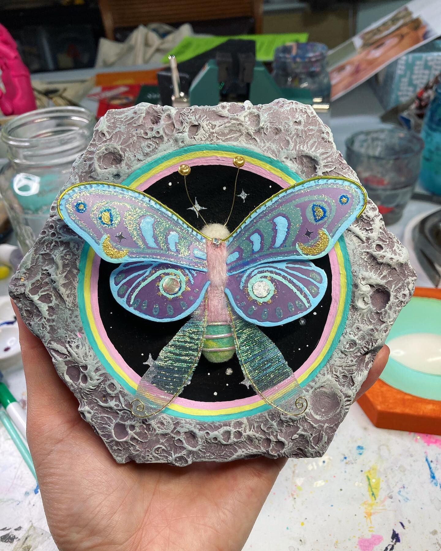 &ldquo;Motherfly&rdquo; mixed media on custom cut hexagon wood panel. I needle felted the body, used duralar and fabric for the wings along with wire and thread.  For the moon texture I used paper clay. I have a bunch of different ideas that will go 