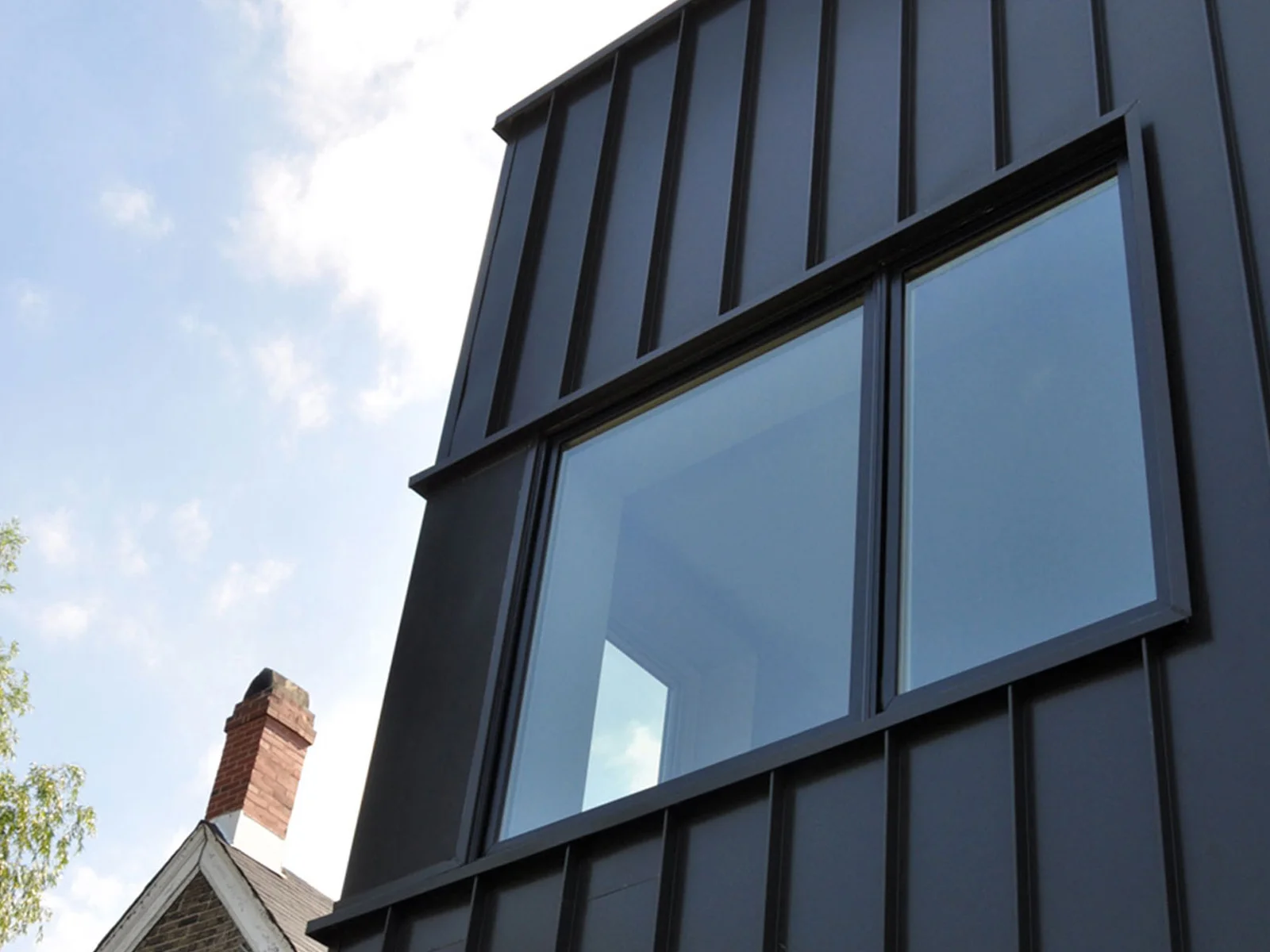 Corner windows bring light into an upstairs bedroom