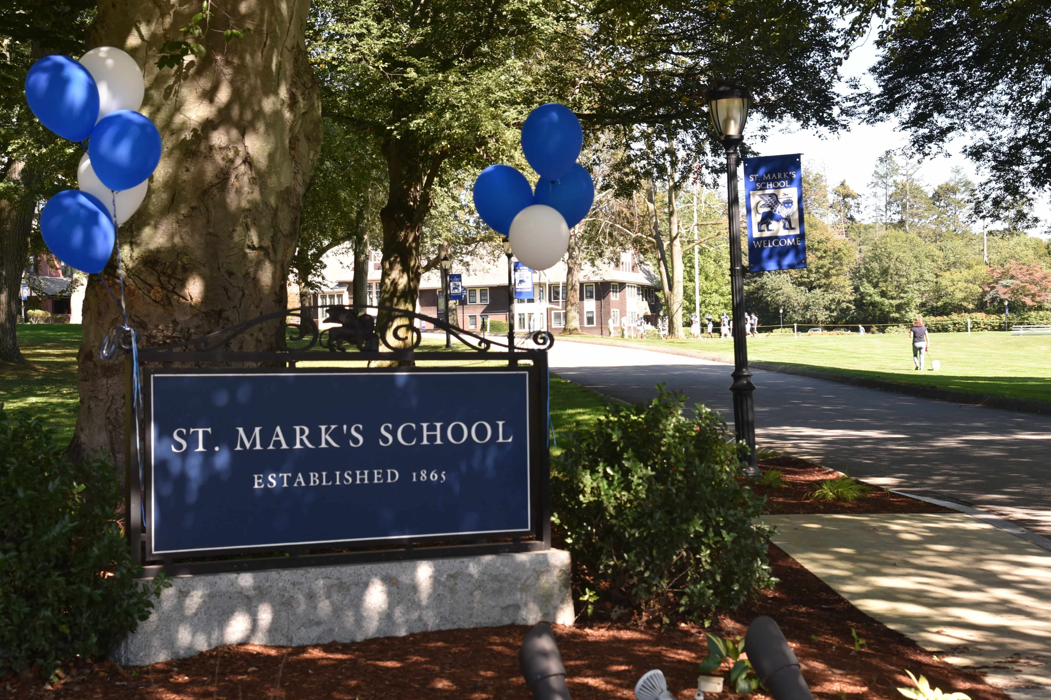 The St. Mark’s School entrance sign stands beside blue and white balloons.