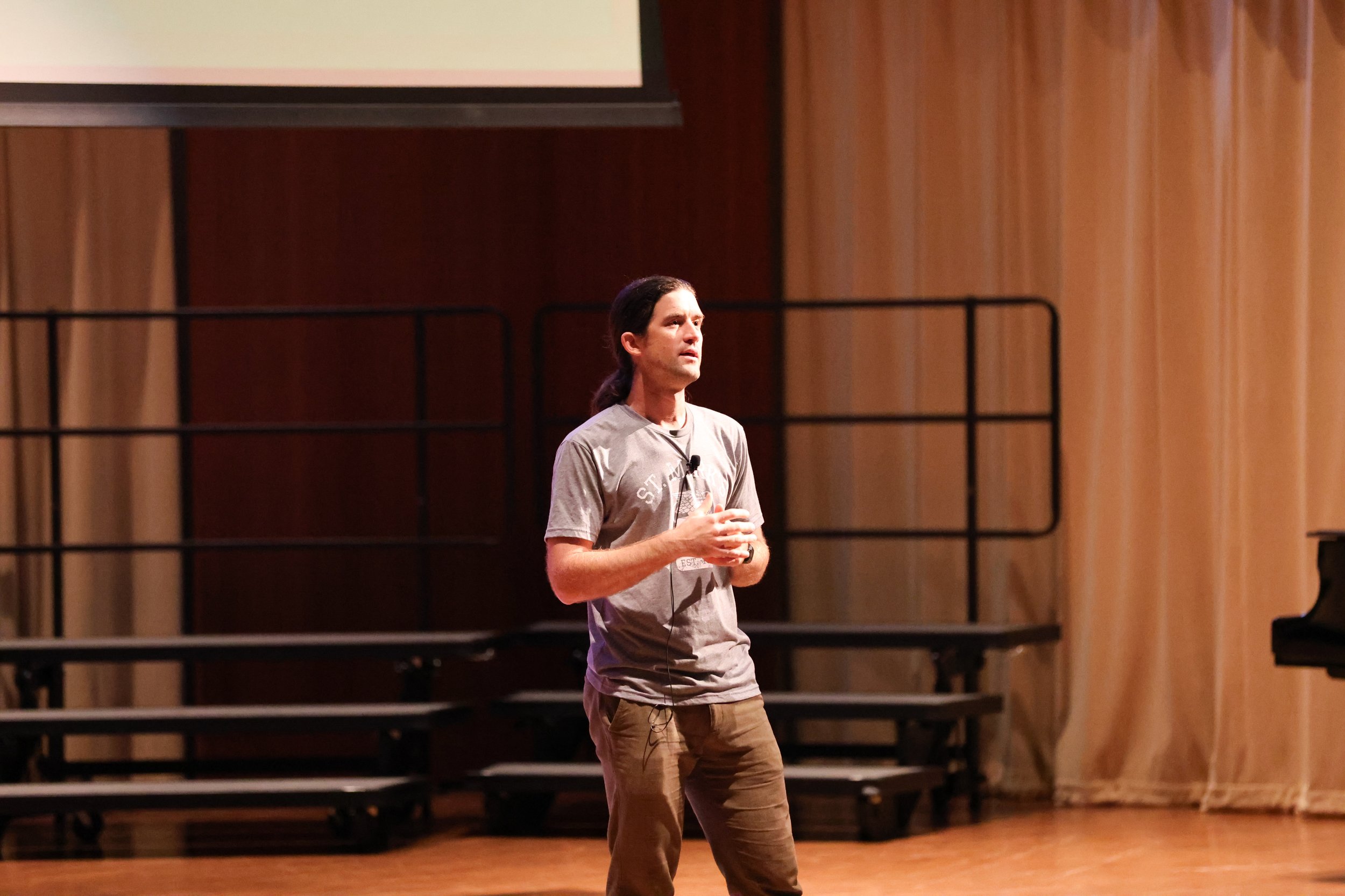 Andrew Forsthoefel speaks on a stage at St. Mark’s School.