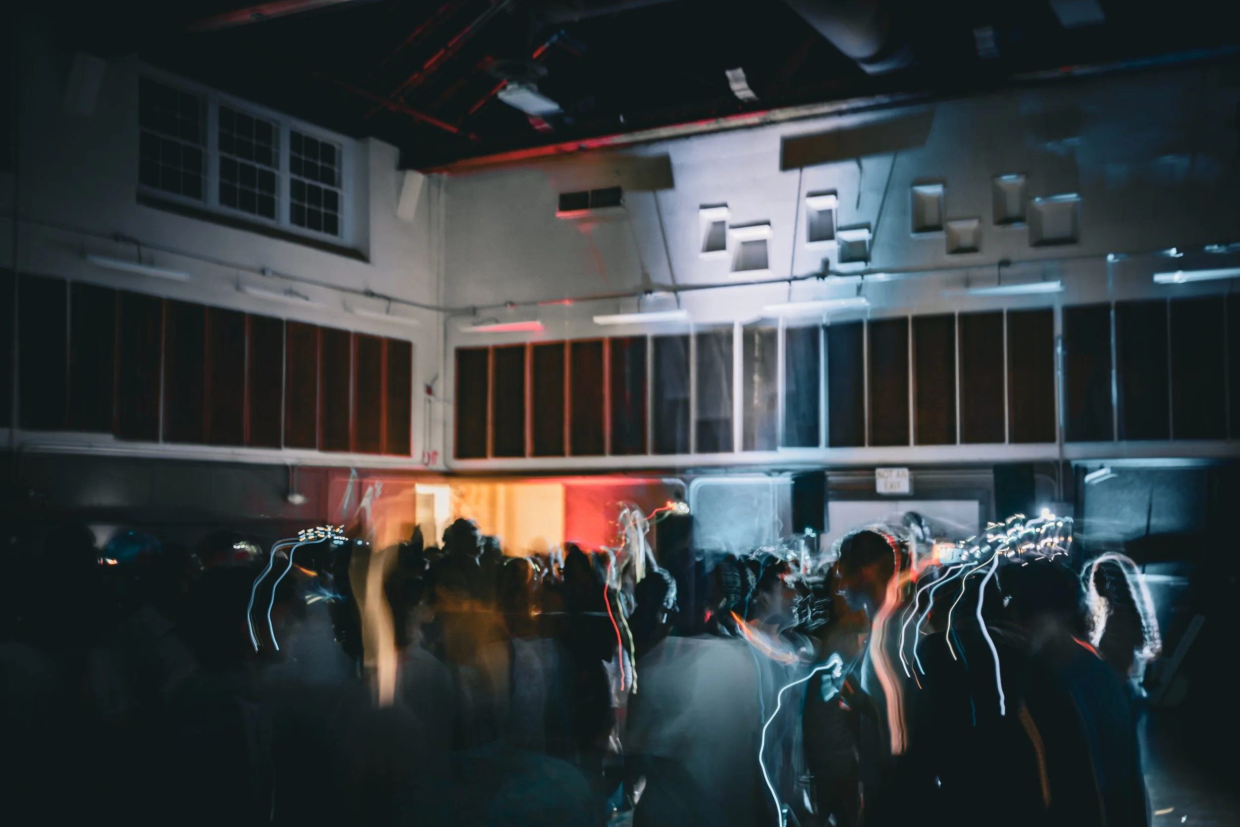 Students dance under colorful lights in Benson at the Neon Dance.