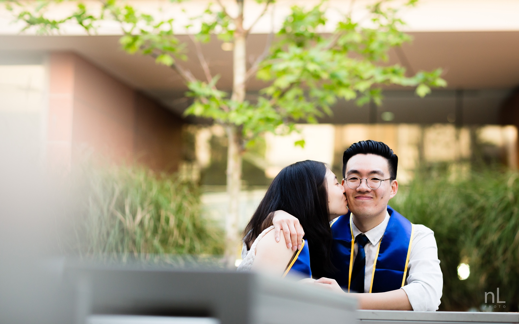 los angeles ucla senior graduation portrait cute couple kissing at ucla engineering building