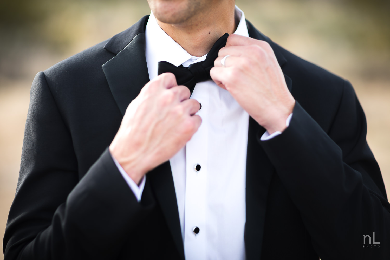 joshua-tree-engagement-wedding-elopement-photography-stylized-photoshoot-groom-adjusting-bow-tie-tuxedo