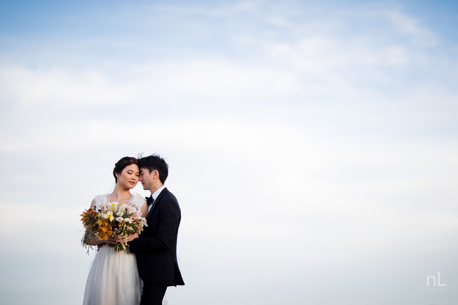 joshua-tree-engagement-wedding-elopement-photography-stylized-photoshoot-epic-environmental-portrait-bride-and-groom-rocks-at-sunset