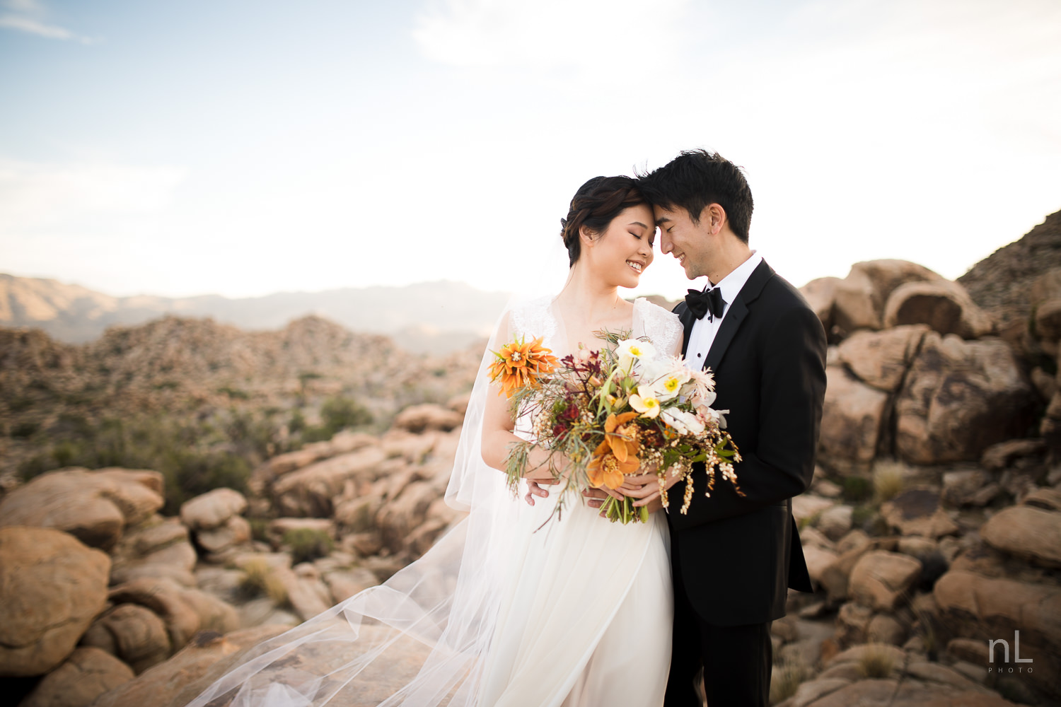 joshua-tree-engagement-wedding-elopement-photography-stylized-photoshoot-epic-environmental-portrait-bride-and-groom-rocks-at-sunset