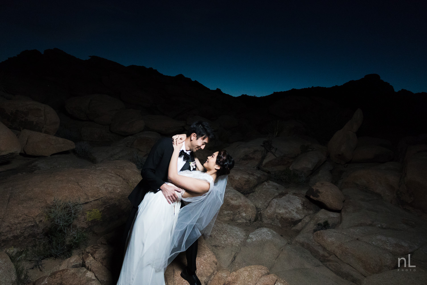 joshua-tree-engagement-wedding-elopement-photography-stylized-photoshoot-epic-environmental-portrait-bride-and-groom-off-camera-flash-blue-hour-dusk