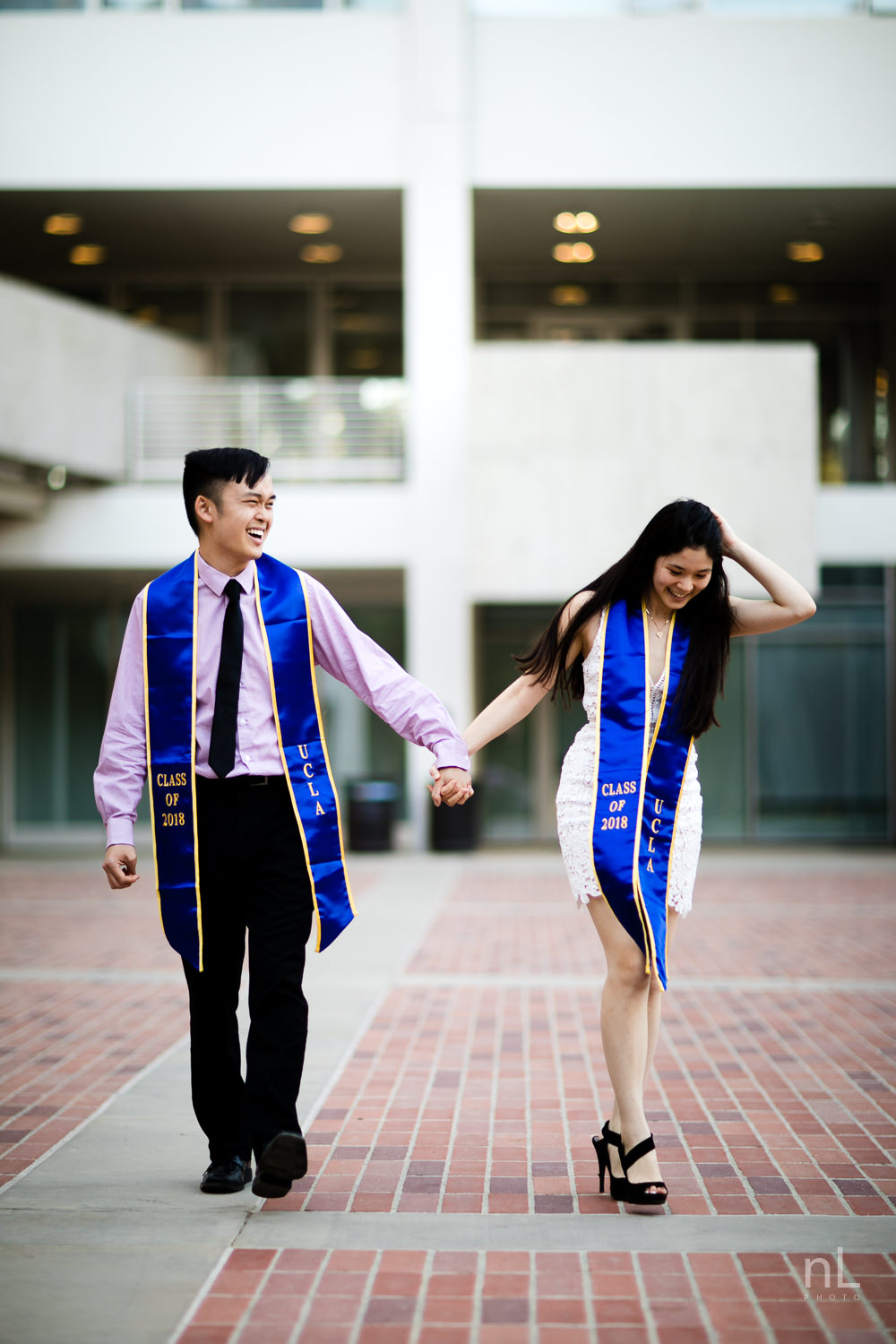 los-angeles-ucla-senior-graduation-portraits-couple-with-sashes-walking-holding-hands