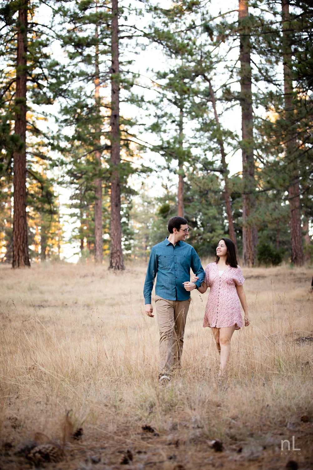 los-angeles-national-forest-engagement-photography-couple-walking-in-wheat-clearing-trees