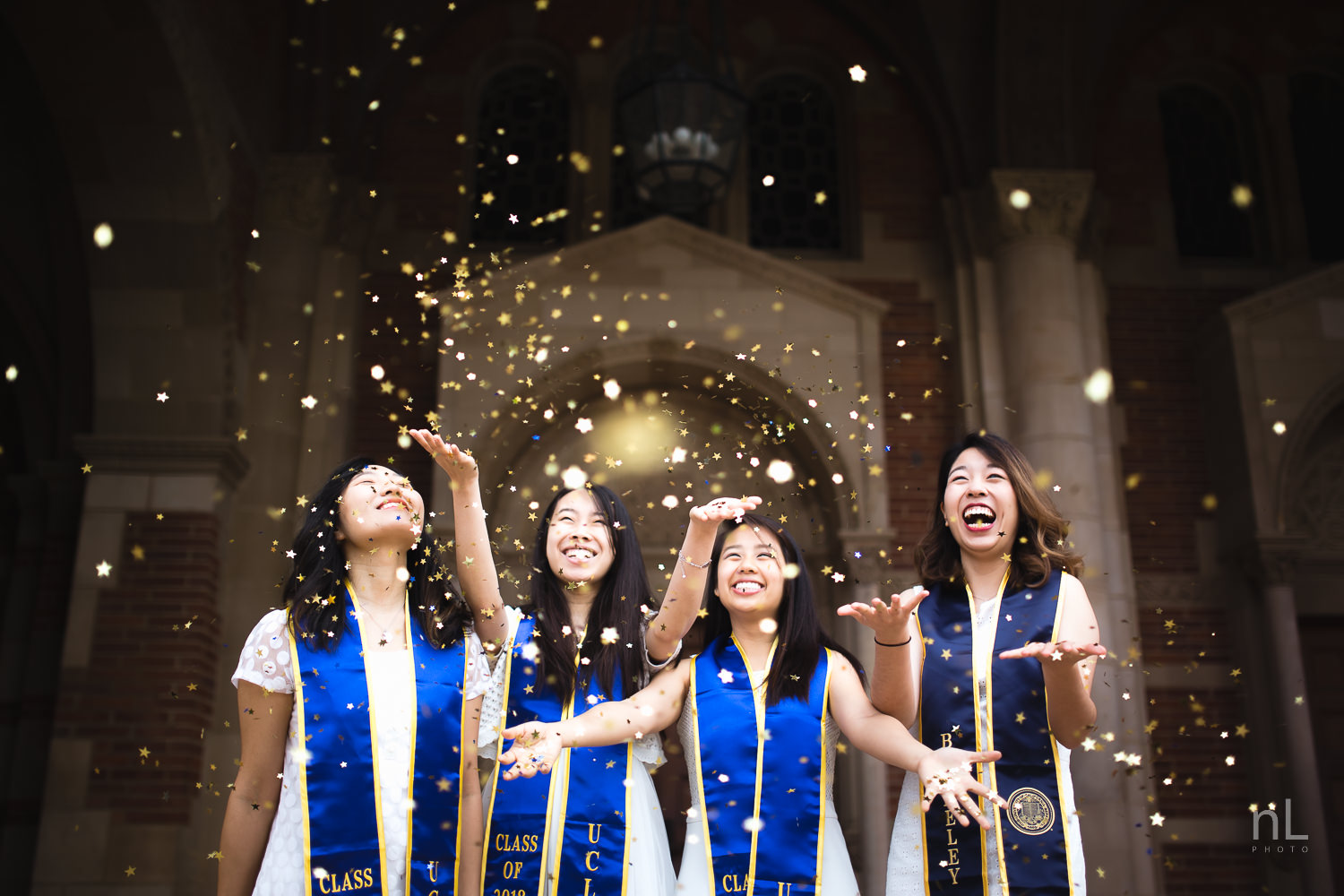 UCLA graduation portraits of friends throwing confetti, celebrating at Royce Hall 