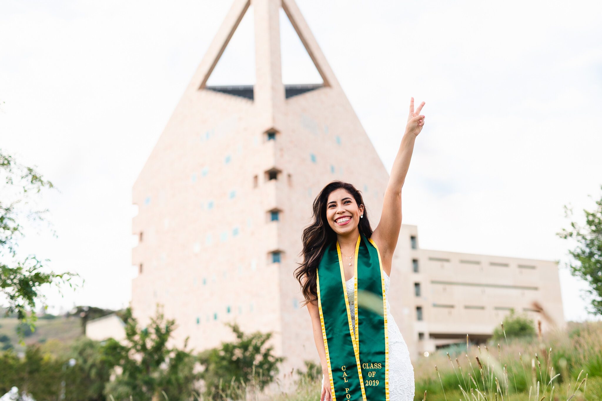 Cal Poly Pomona CPP Graduate Portrait with graduation sash at CLA Building