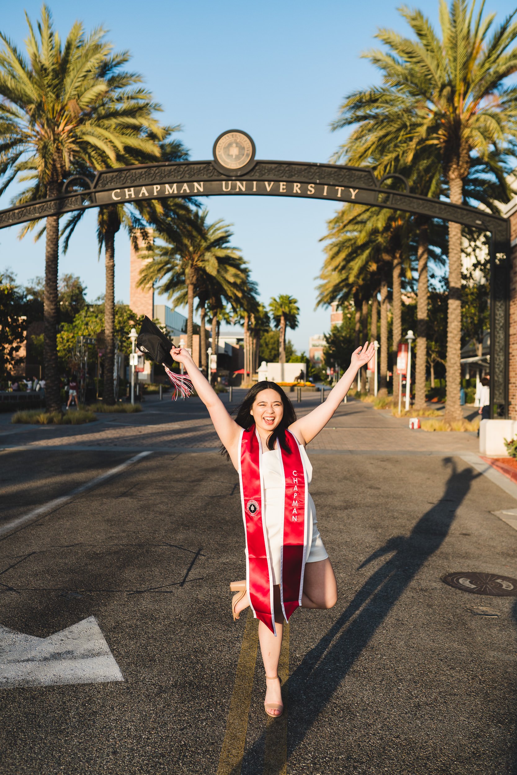 Chapman University Graduation Portraits at famous arch sign, at sunset. Orange County, CA