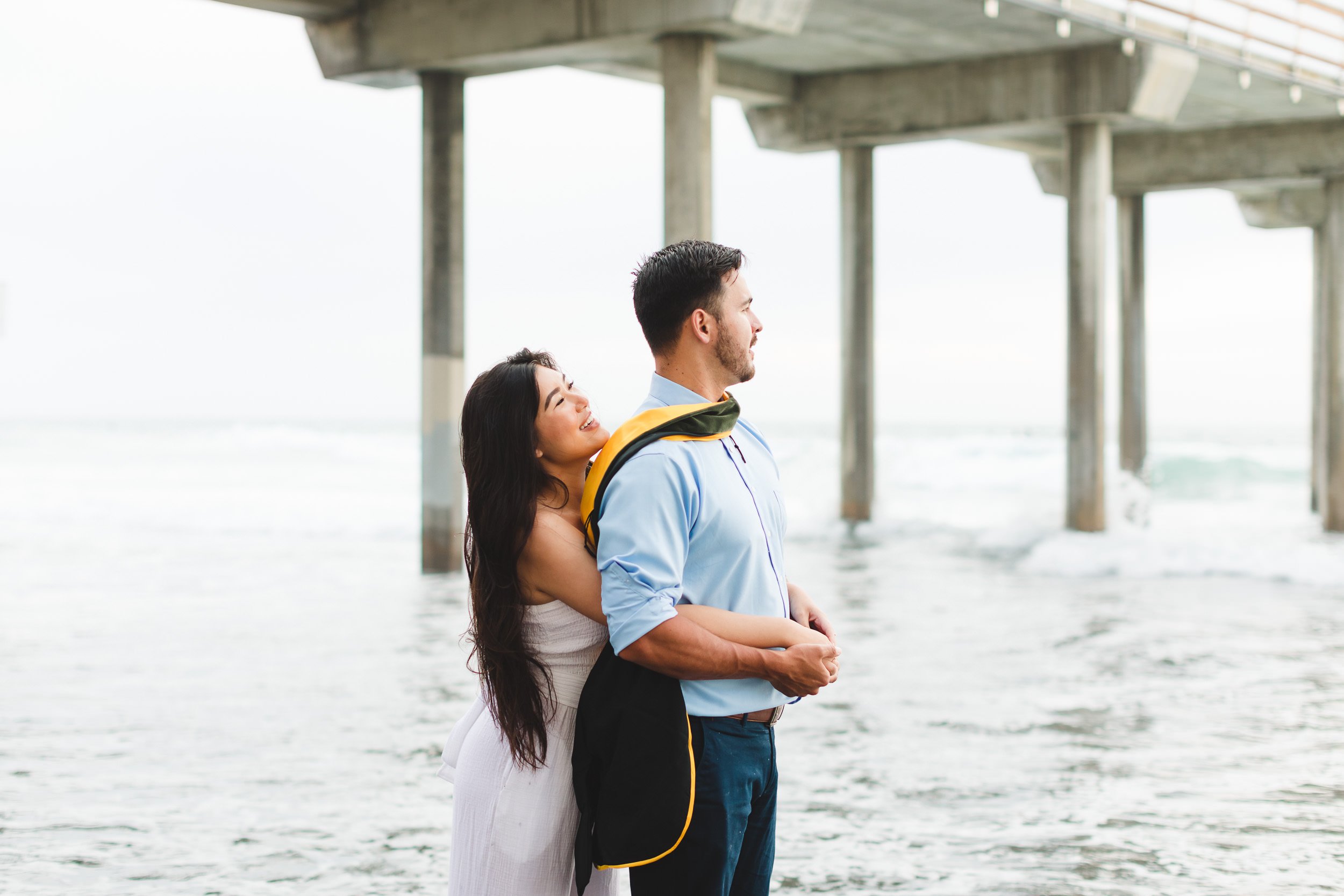  Graduation portraits for couples, PhD graduate with boyfriend at the beach.  Los Angeles, CA