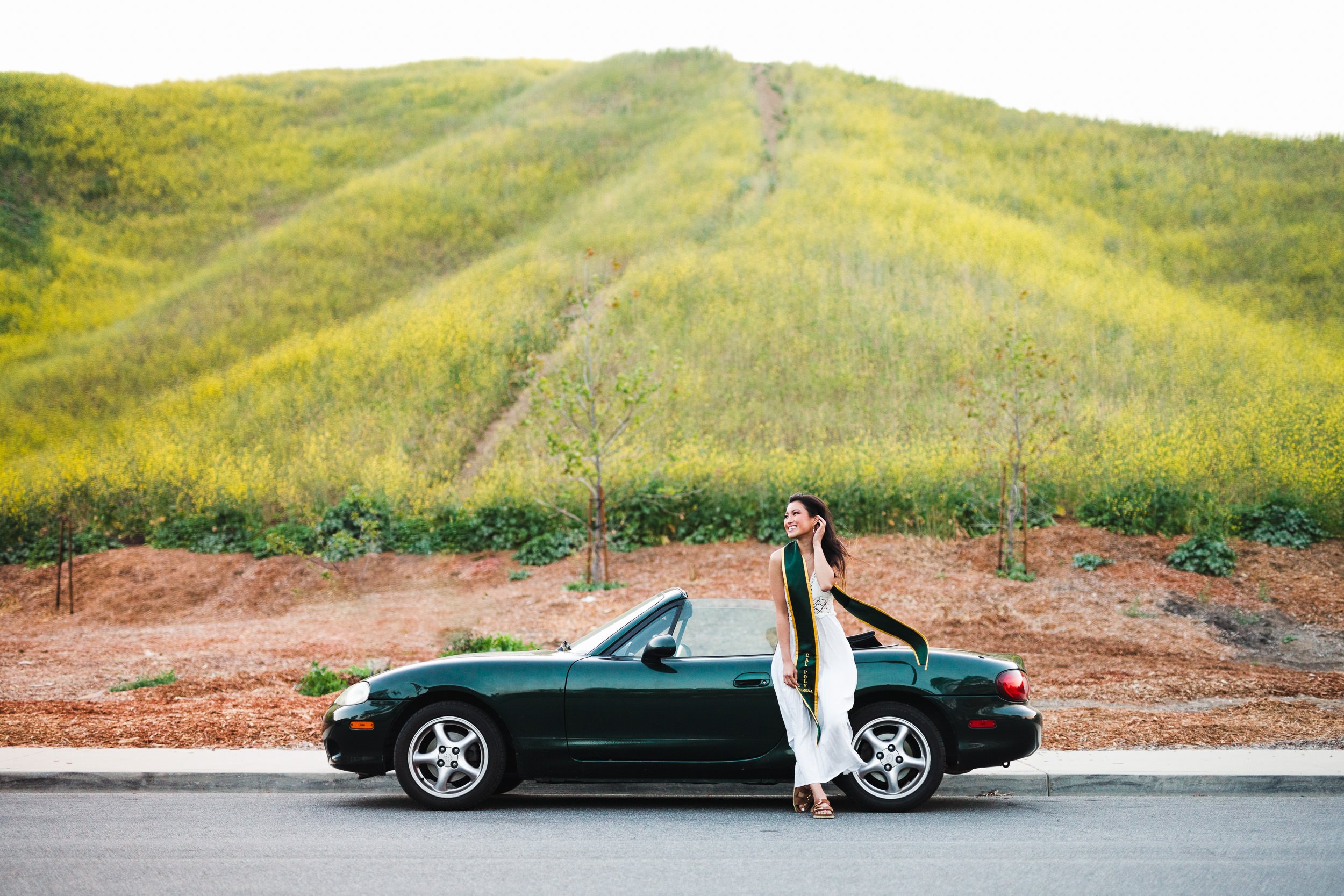 Epic Los Angeles Graduation Portraits of graduate with her car, Miata in wildflowers superbloom. Chino Hills State Park