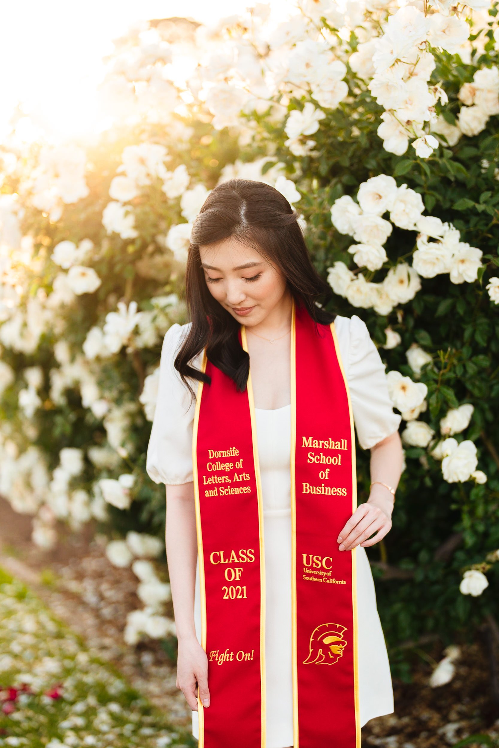 Dreamy graduation portrait at USC Rose Garden at sunset