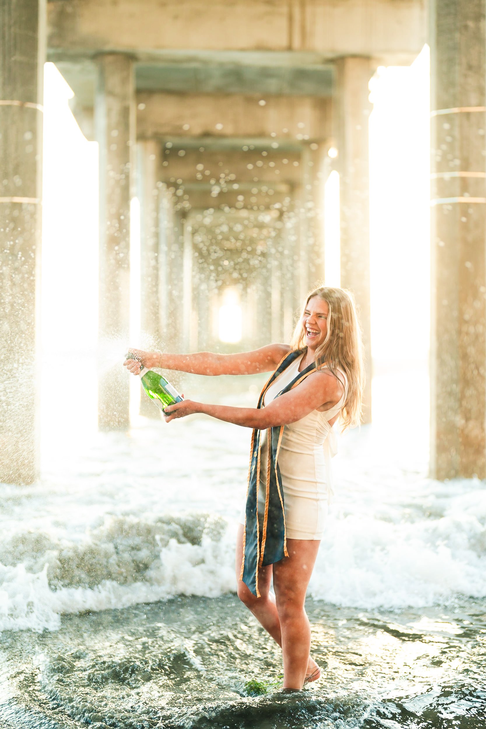 Graduation portraits with champagne at the beach