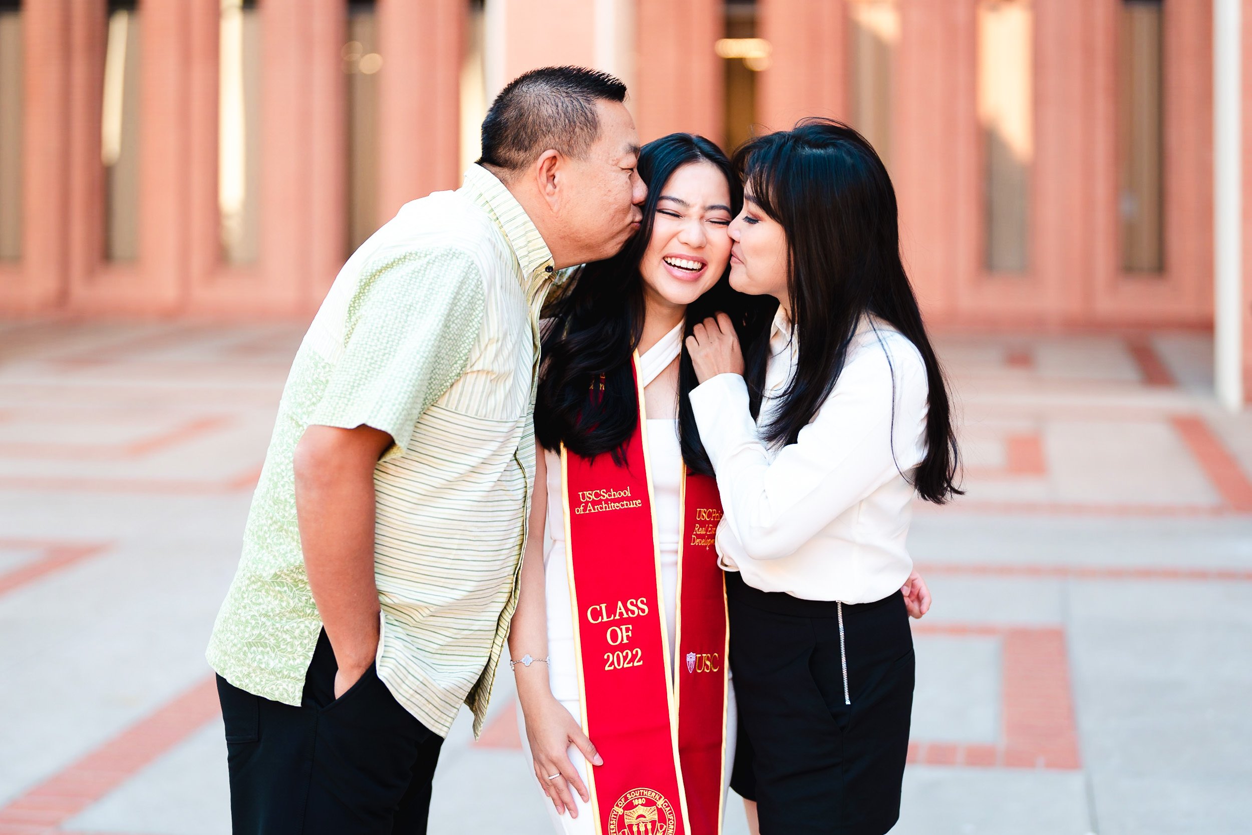 Candid graduation portrait of graduation with parents