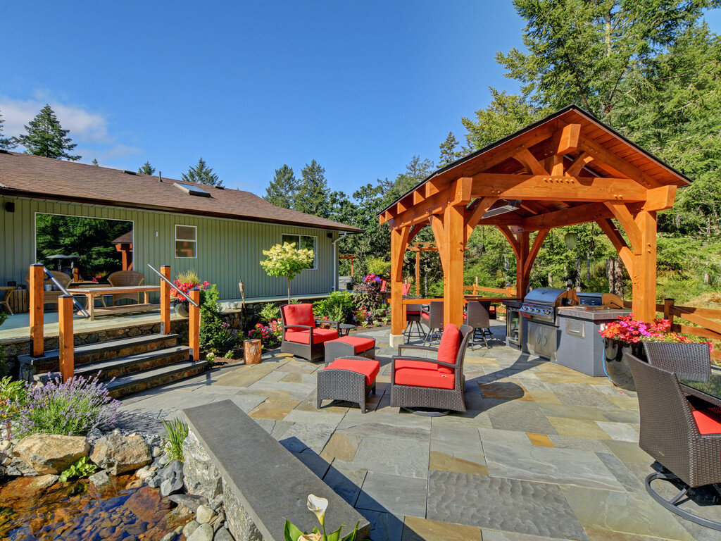 granite-interlocking-bricks-pavers-capstone-outdoor-living-island-timber-frame-kitchen-steps-salvia-pond-blue-stone.jpg