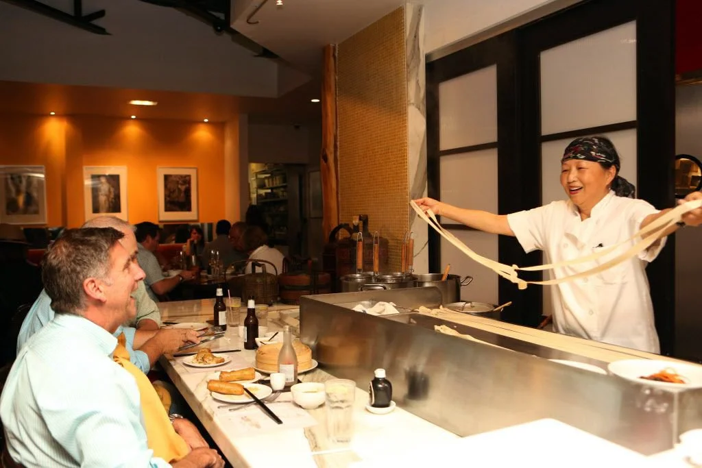 Hand-made noodles being prepared for seated patrons at the dumpling bar only at Royal China