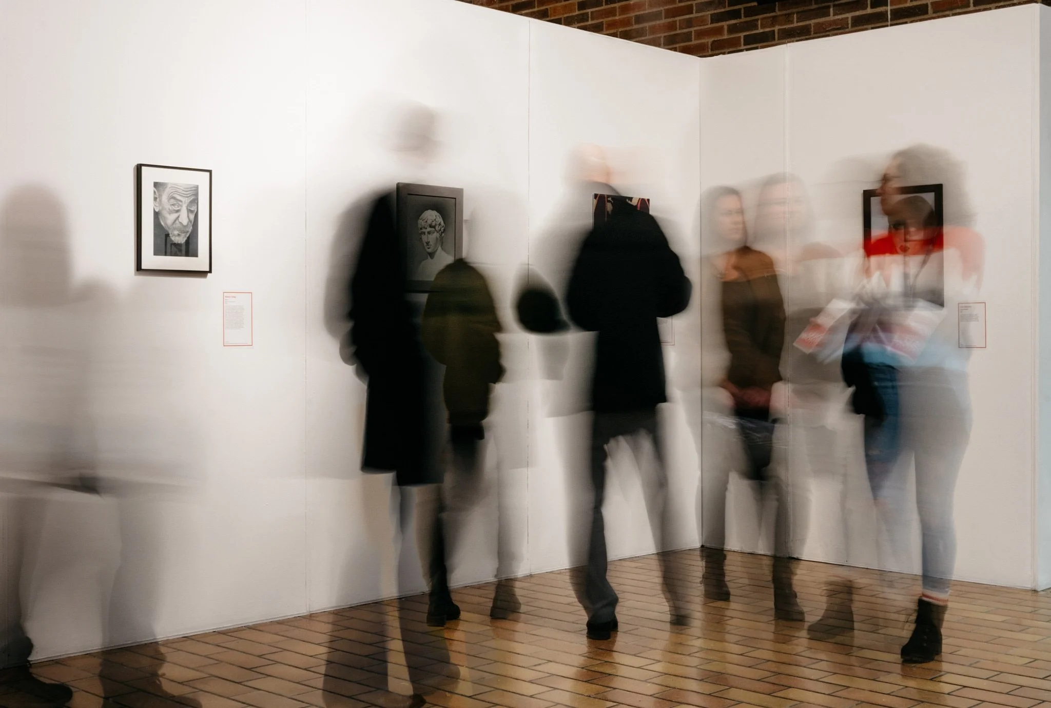 Motion-blurred crowd of art lovers moving through the AU Arts student show-off in Calgary. Captured by Stance Creative, professional Calgary event photographer.