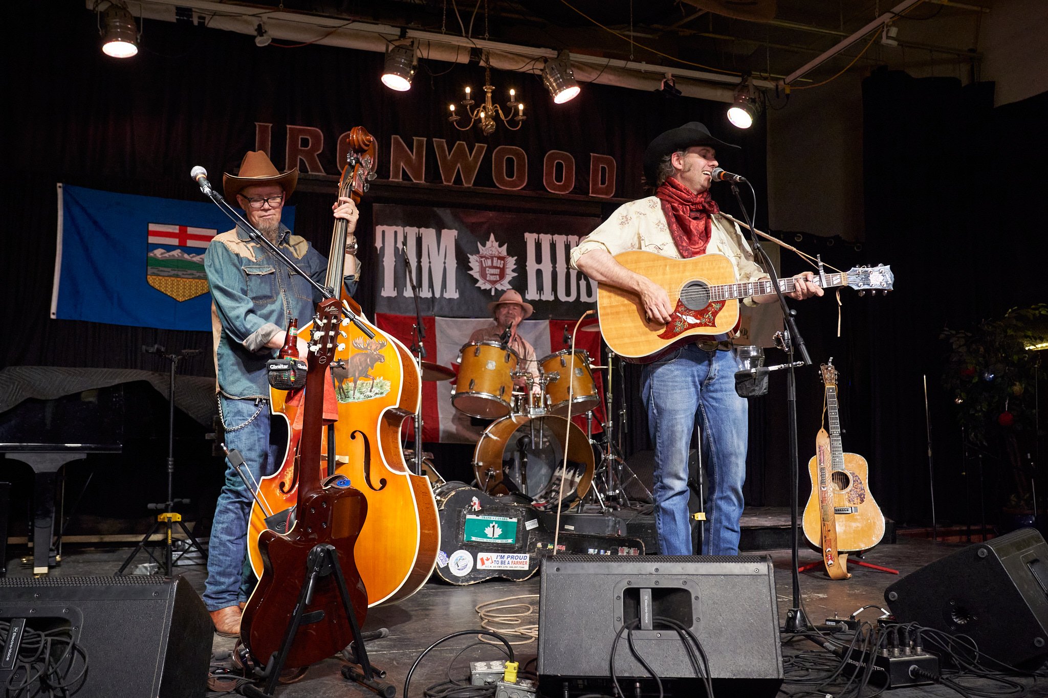 Tim Hus and his band rocking the stage at the Ironwood – bassist Spider Bishop, and drummer Thom Moon. High-energy Calgary live performance captured by Stance Creative event photographer.