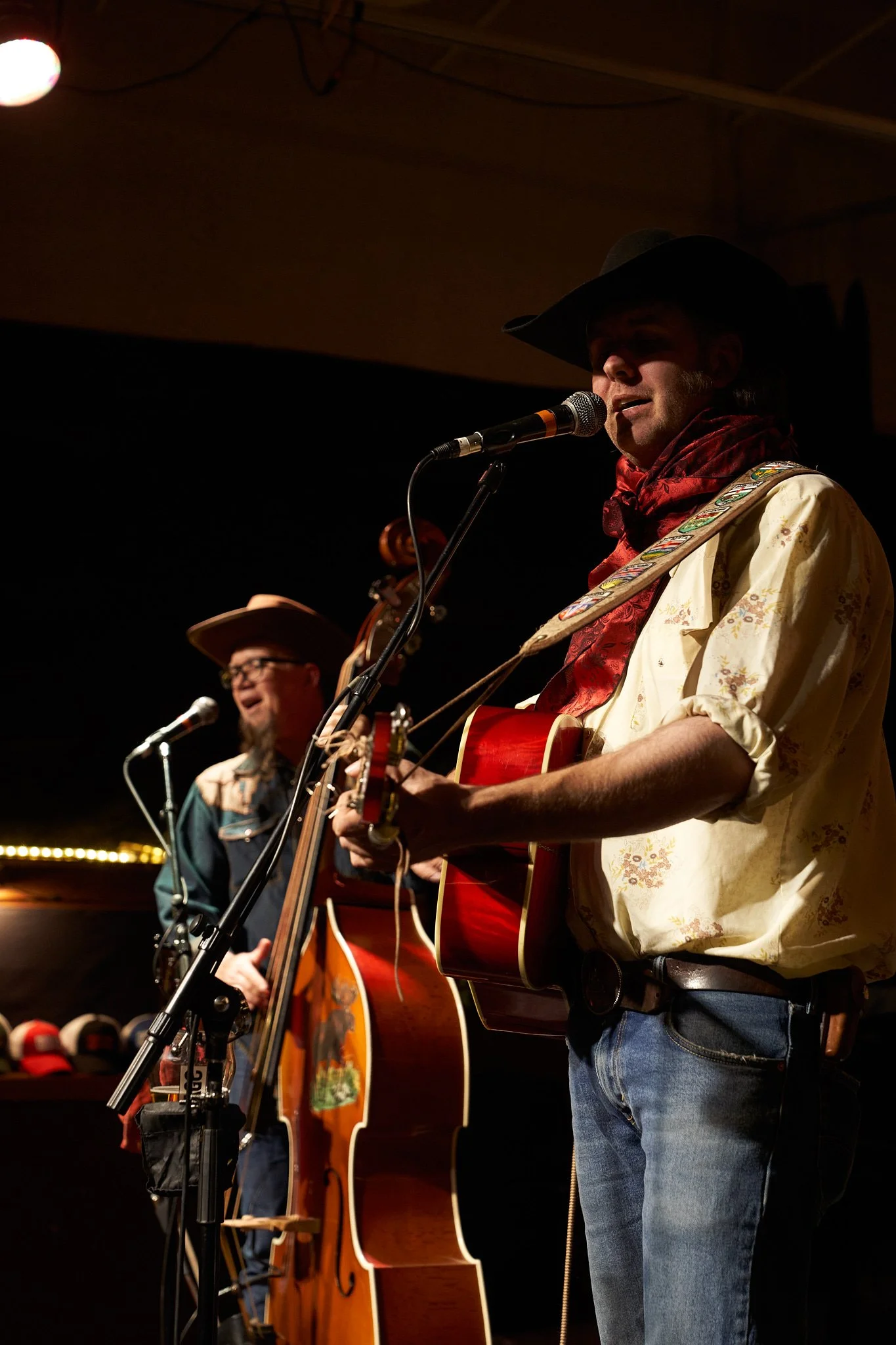 Country musician Tim Hus performing at the Ironwood Stage and Grill Calgary's Inglewood neighbourhood. Red scarf and embroidered shirt adding flair. Authentic country music moment by Stance Creative.