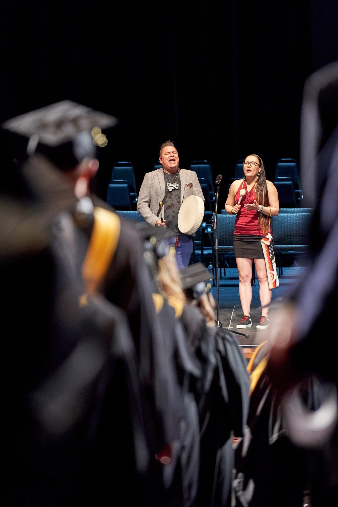 Indigenous performers on stage at the AU Arts Convocation Ceremony in Calgary Alberta. Event Photography captured by Stance Creative.