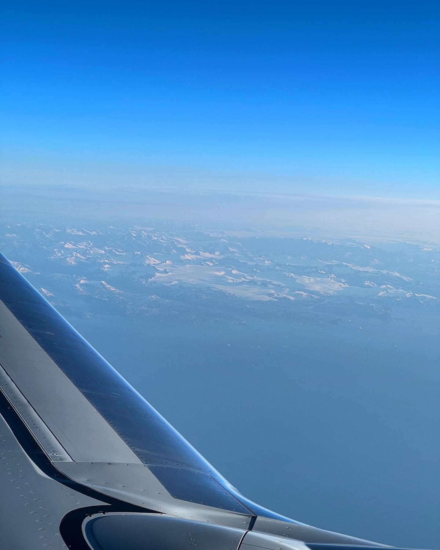 The southern tip of Greenland from the clouds. #greenland