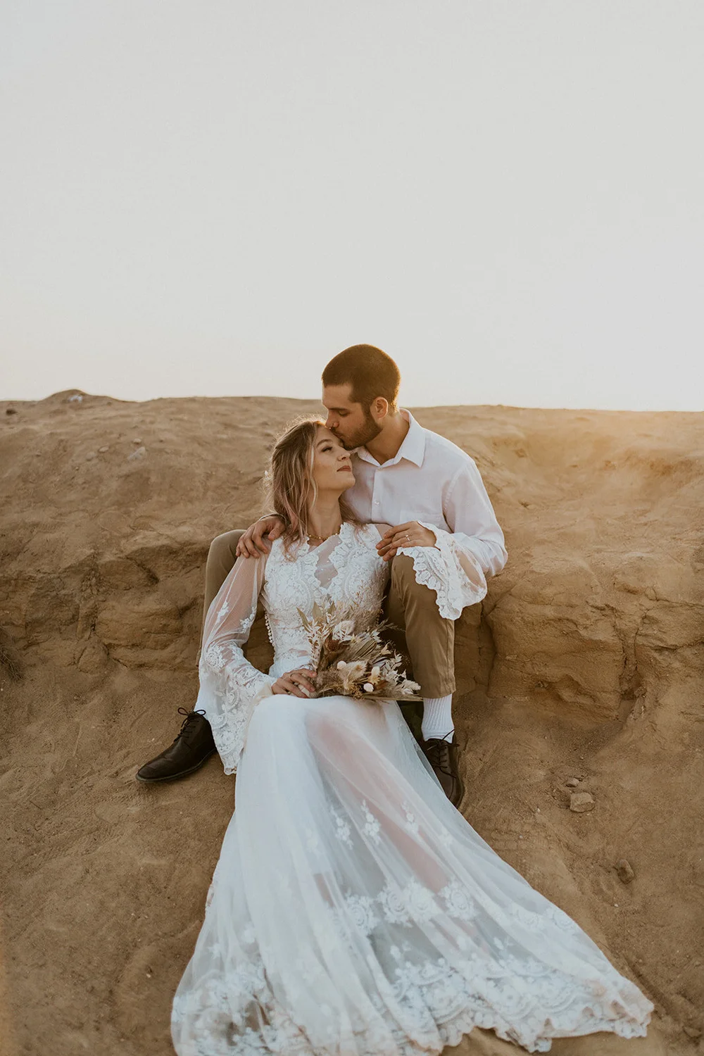 Elora wedding dress with long sleeves and open back, plunge neckline and  cotton lace.  Daci Gowns