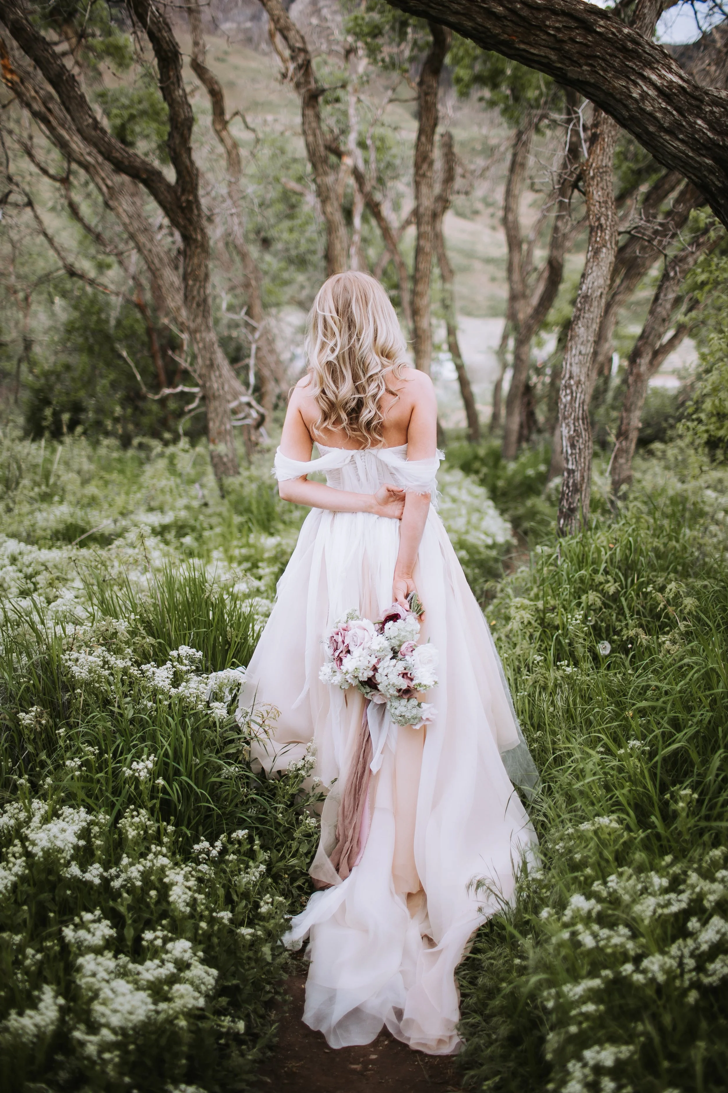 Romantic wedding dress for creative bride in wildflower meadow