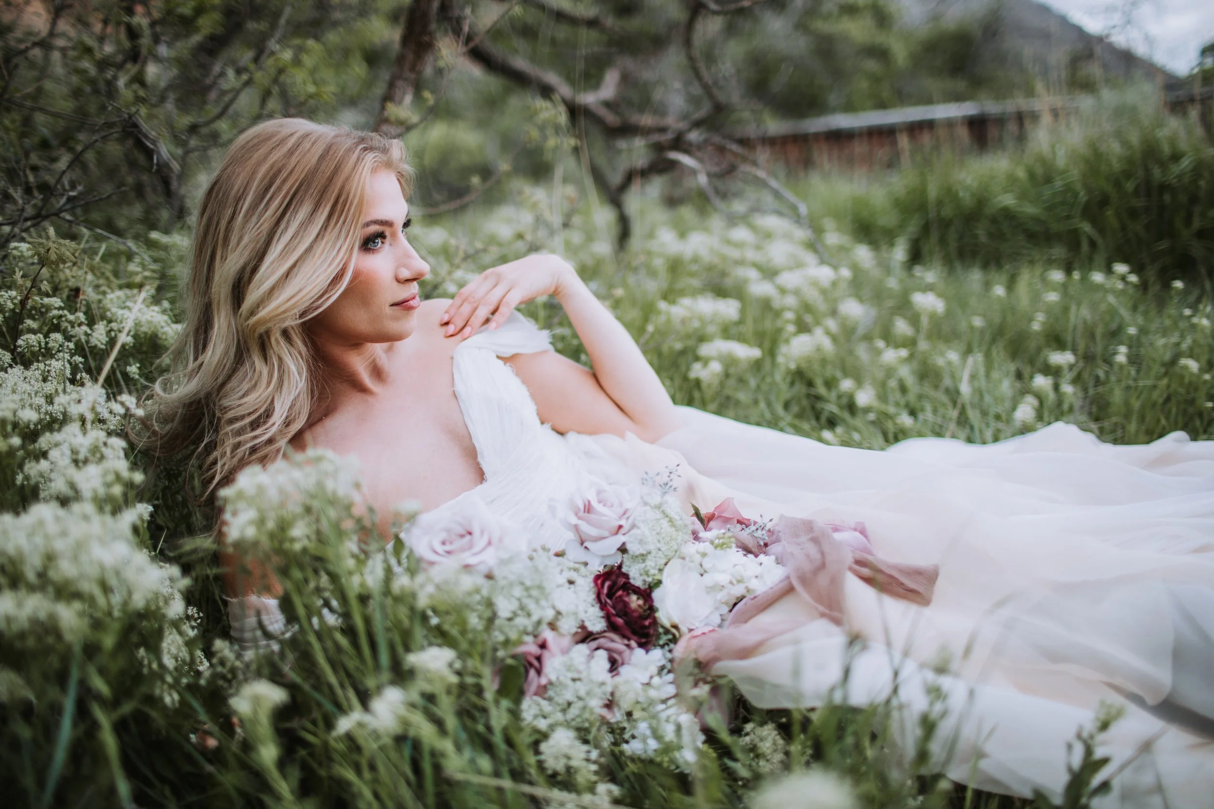Bohemian bridal portrait with wildflowers and blush silk wedding gown