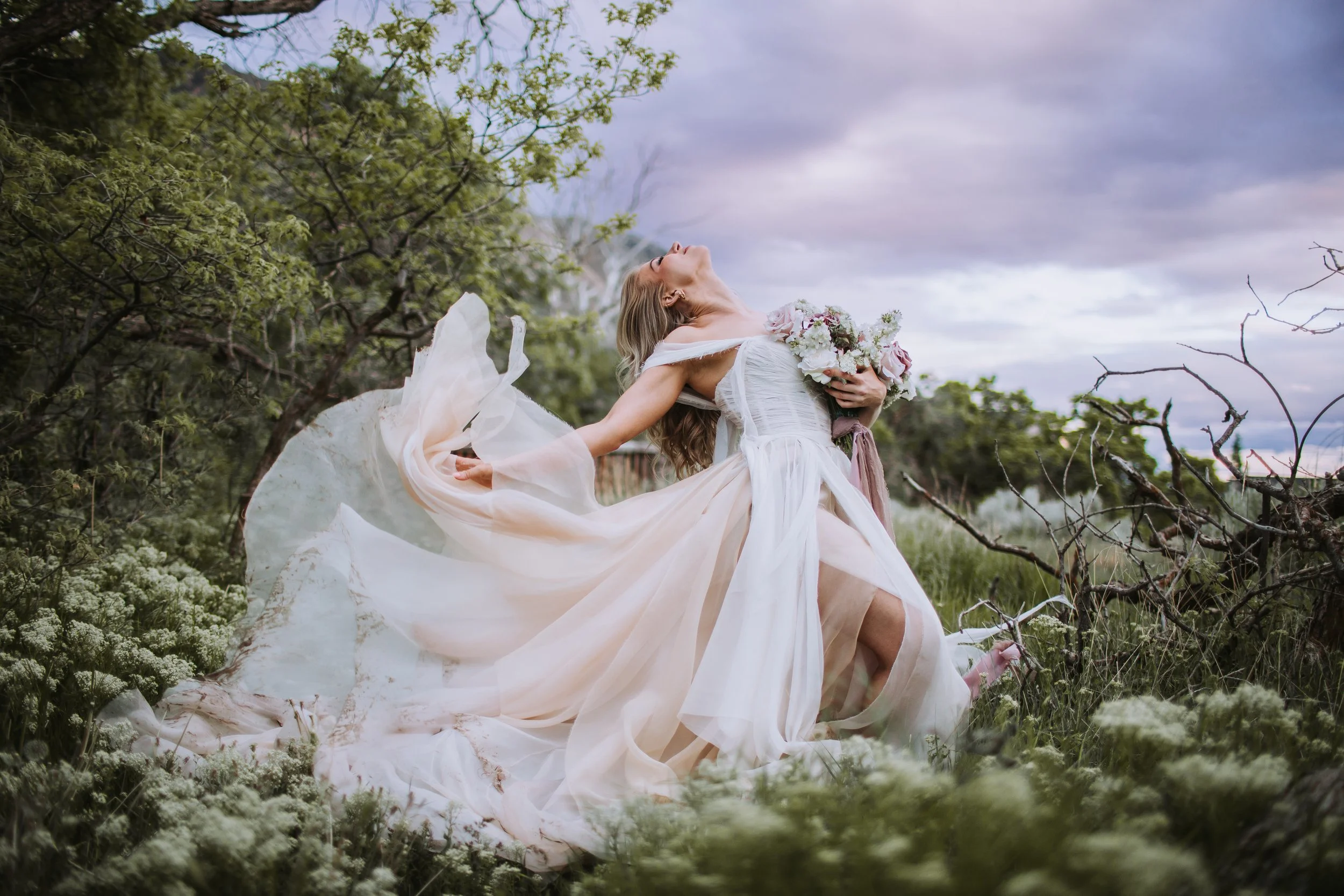 Ethereal bride in blush silk chiffon wedding gown in nature forest