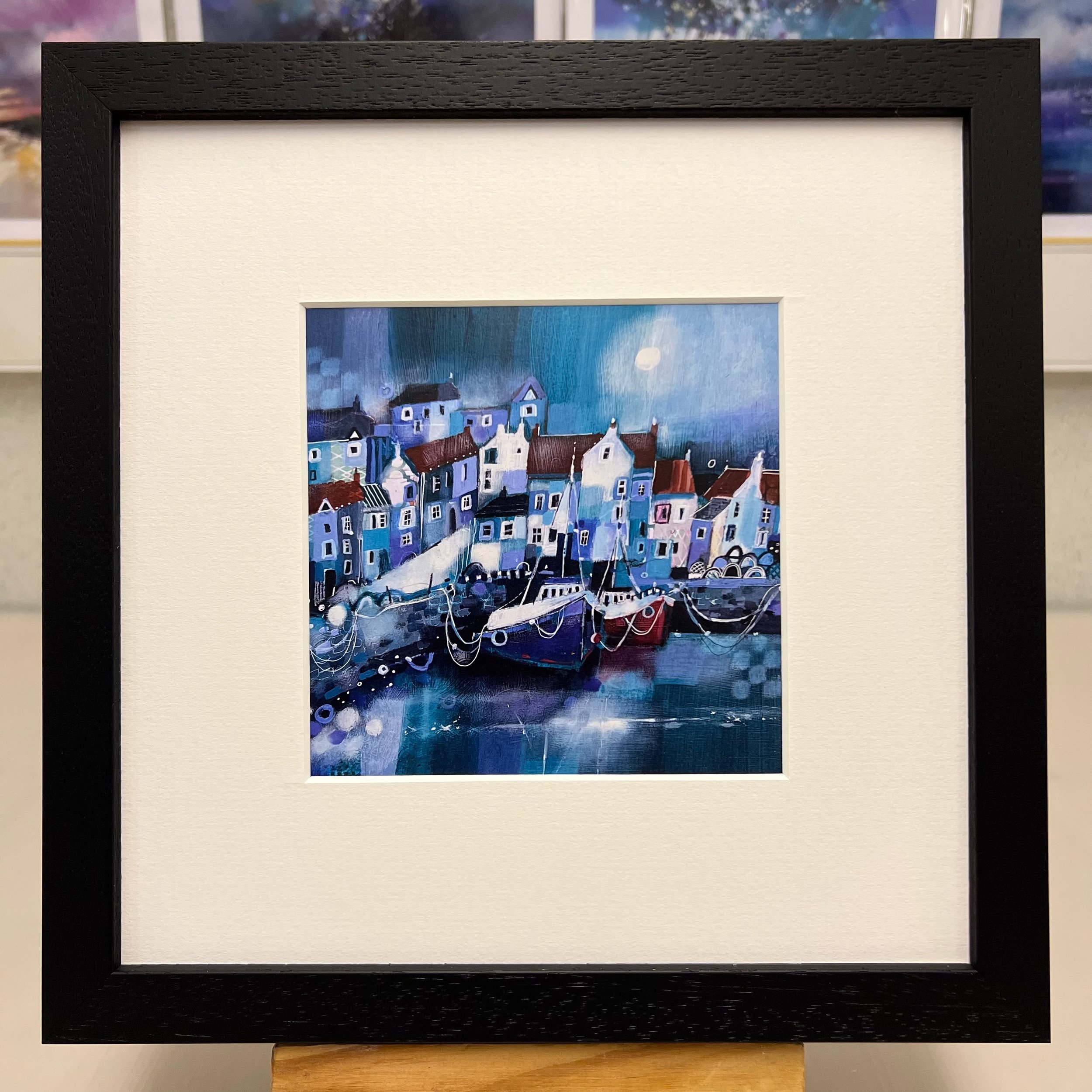Pittenweem harbour comes to life in Emma S Davis Artist's art greetings card framed in black