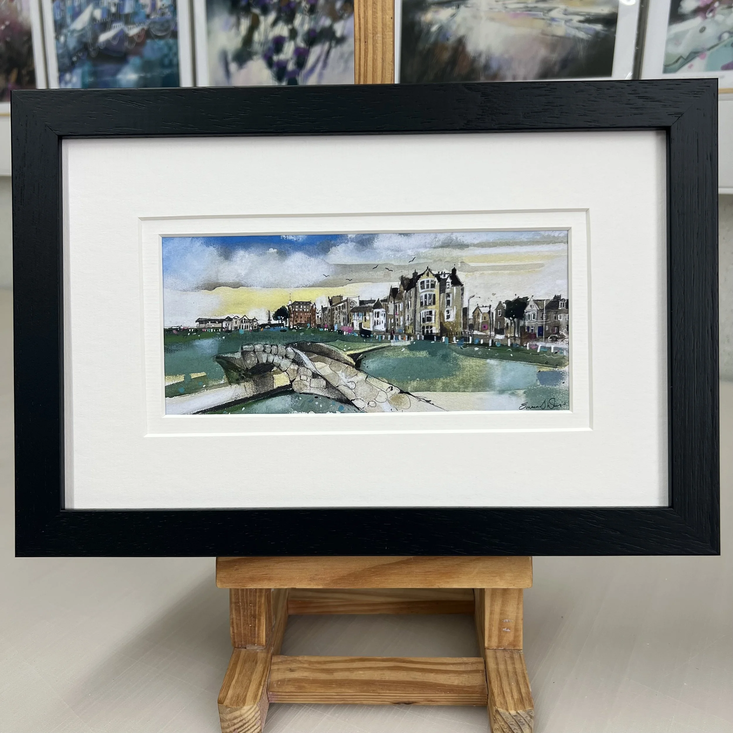 Framed Swilcan Bridge St Andrews artwork showing Old Course 18th green and clubhouse. Black frame double mount