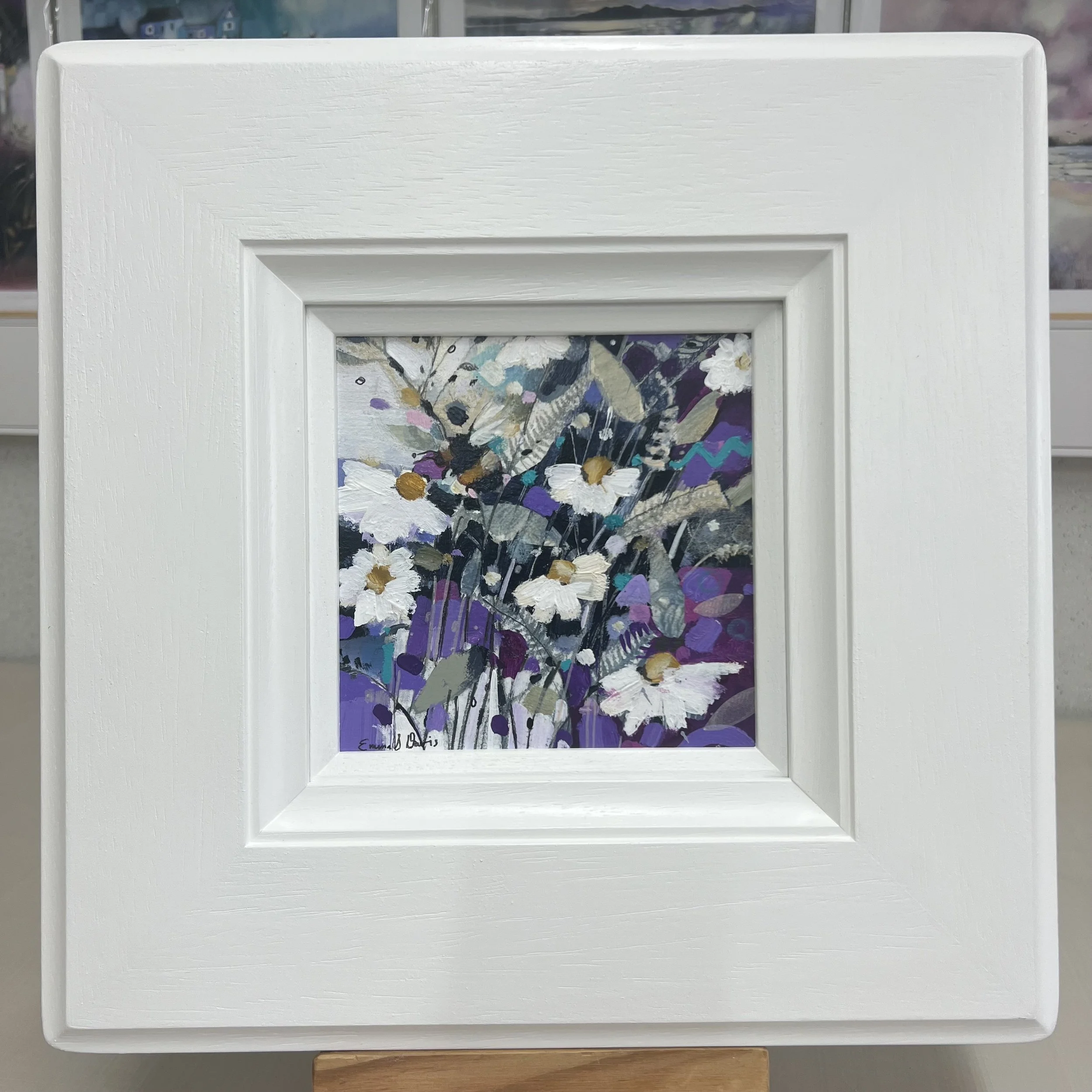 Original painting of bees at work amongst daisies and other wildflowers by Emma S Davis Artist. Framed view.