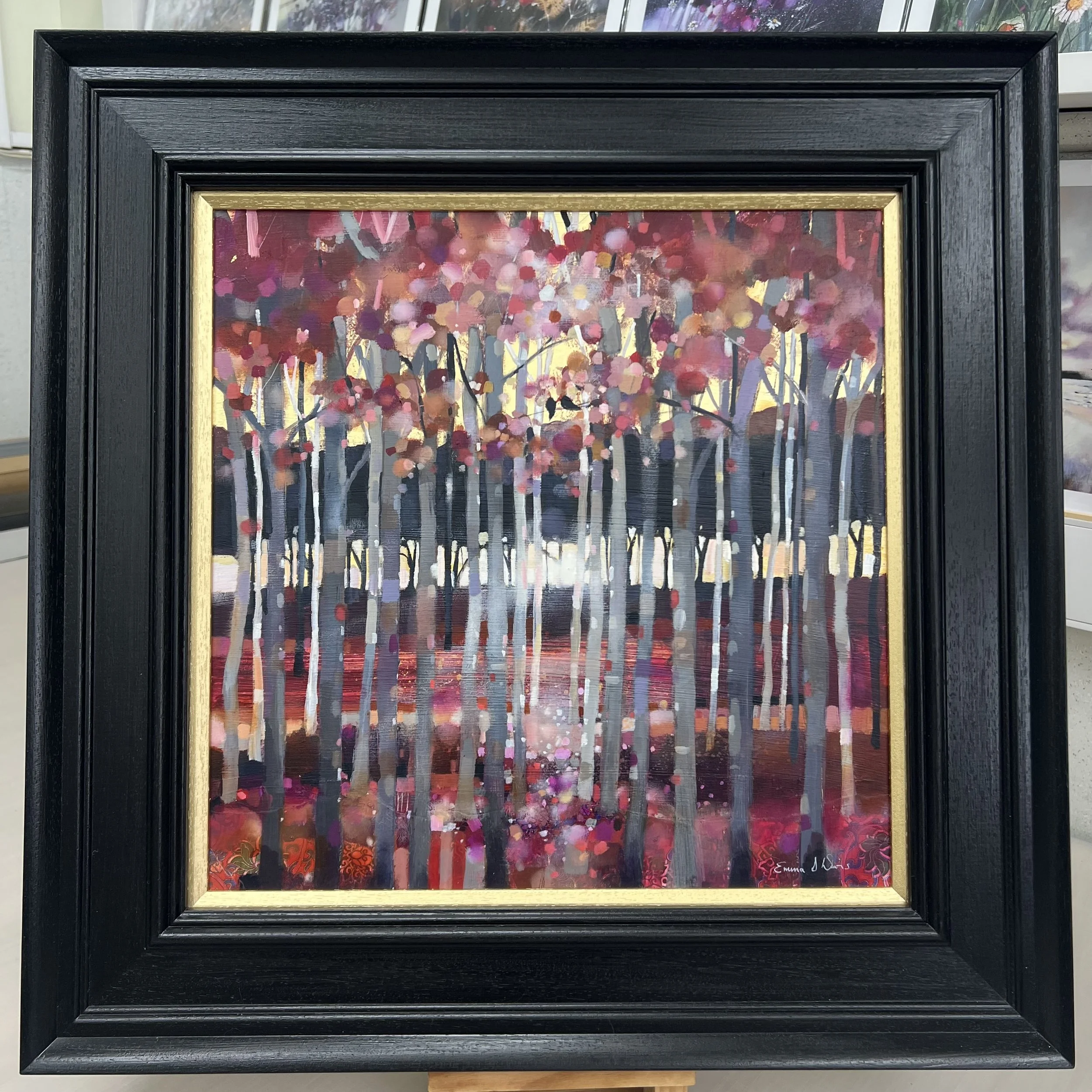 Original oil painting of two birds perched in a silver birch woodland with pink blossom and golden light by Scottish artist Emma S Davis. Framed view.