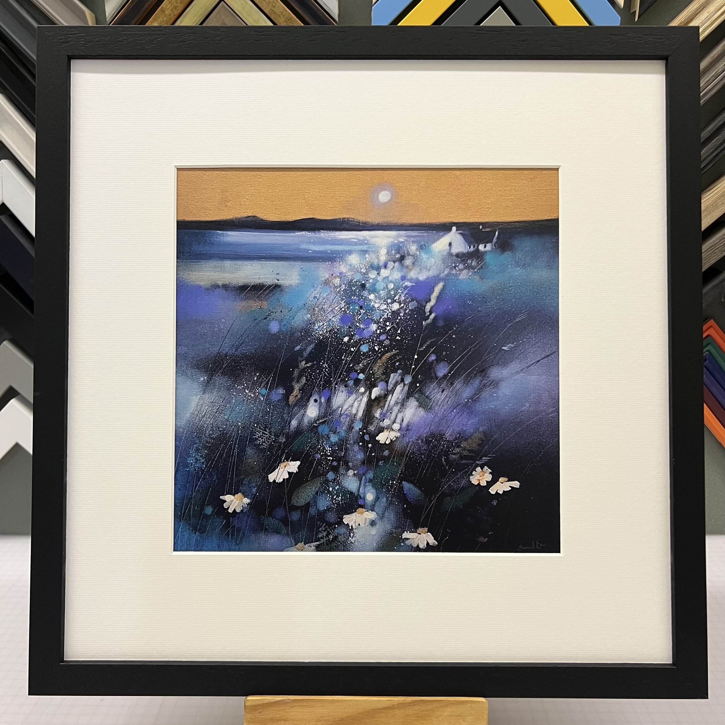 Moonlight And Gigha Open Edition Art Print by Emma S Davis. Presented in a black frame, showcasing the enchantment of a moonlit view from Kintyre to the Isle of Gigha.