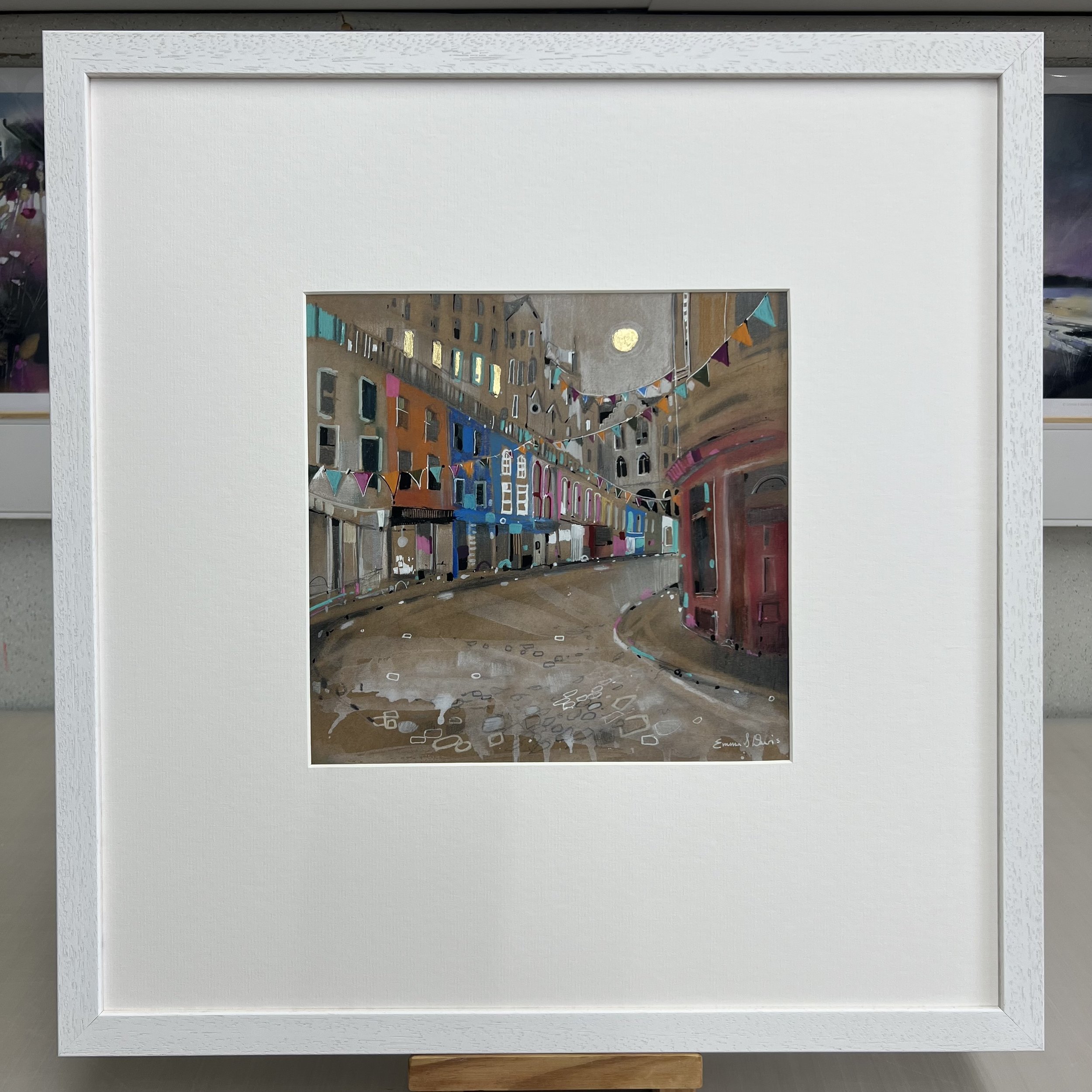 Bunting, Victoria Street, Edinburgh by Emma S Davis – original mixed media artwork featuring colourful bunting and the famous curved street in Edinburgh’s Old Town. Framed view.