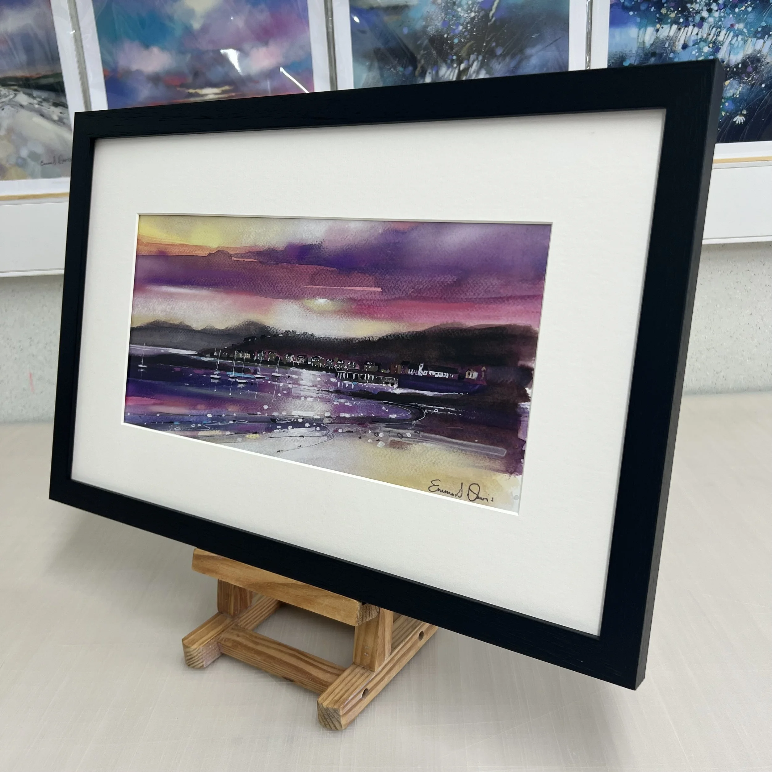 Millport beach looking towards West Bay and Arran beyond on the Isle of Cumbrae, Scotland depicted beautifully in Emma S Davis Artist's open edition framed art print.