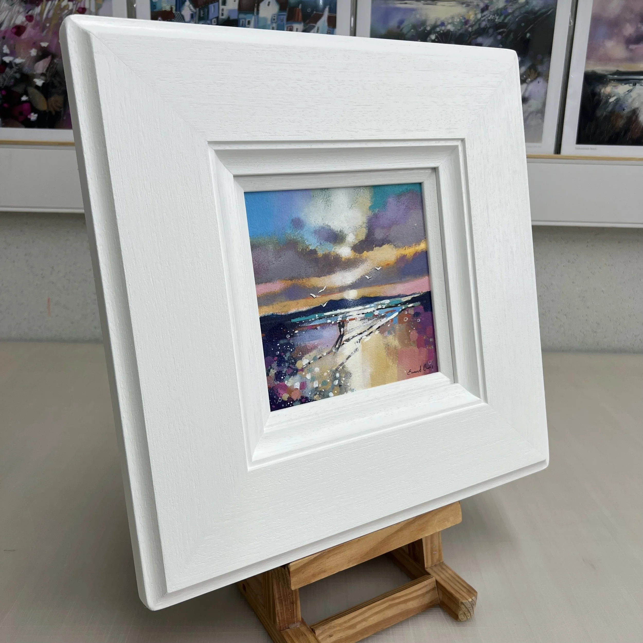 The Isle of Arran's silhouette frames couple walking along Seamill Beach in an original painting by Emma S Davis Artist. Alternate view.