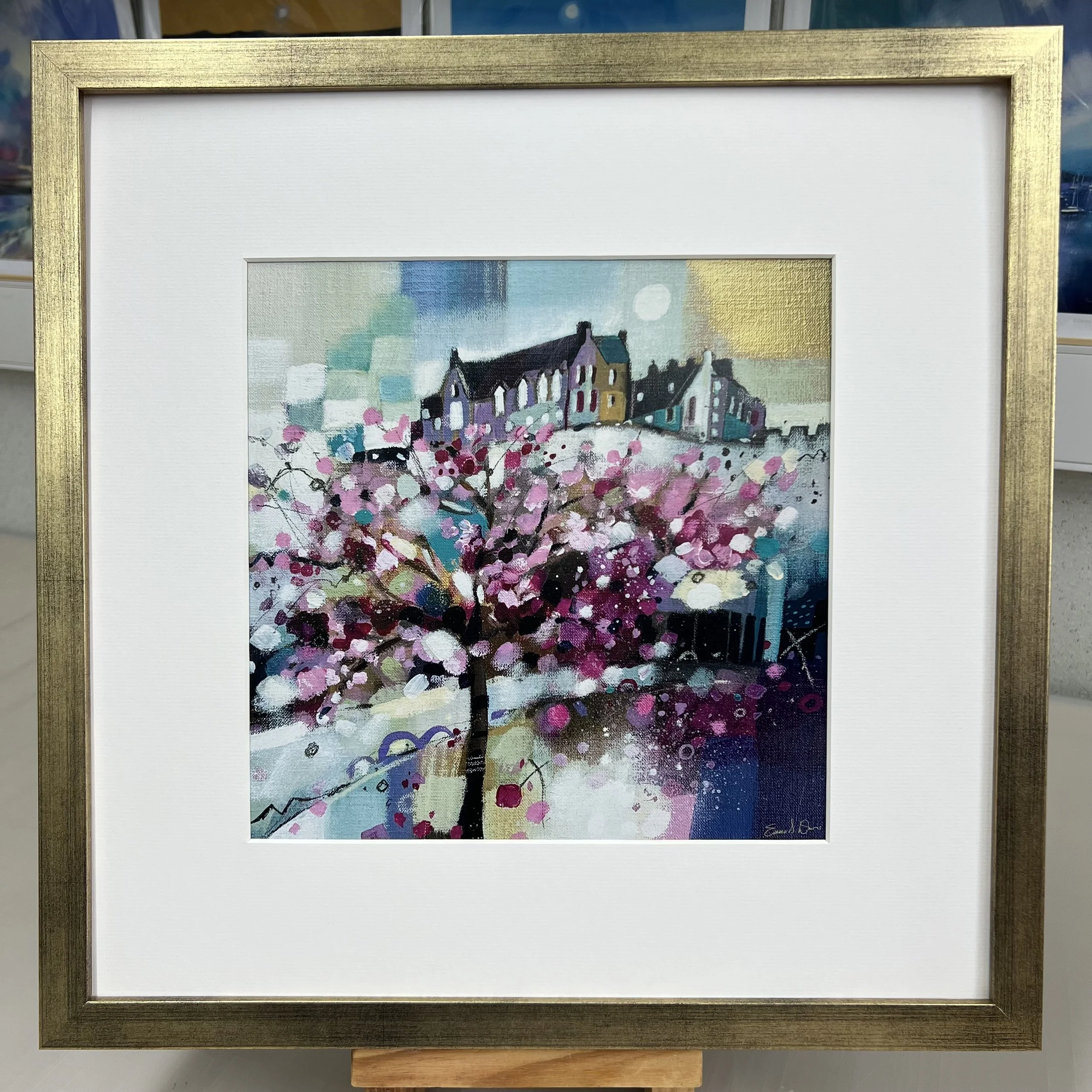 Blossom trees in Princes Street Gardens below Edinburgh Castle come to life in Emma S Davis Artist's open edition art print with gold frame.
