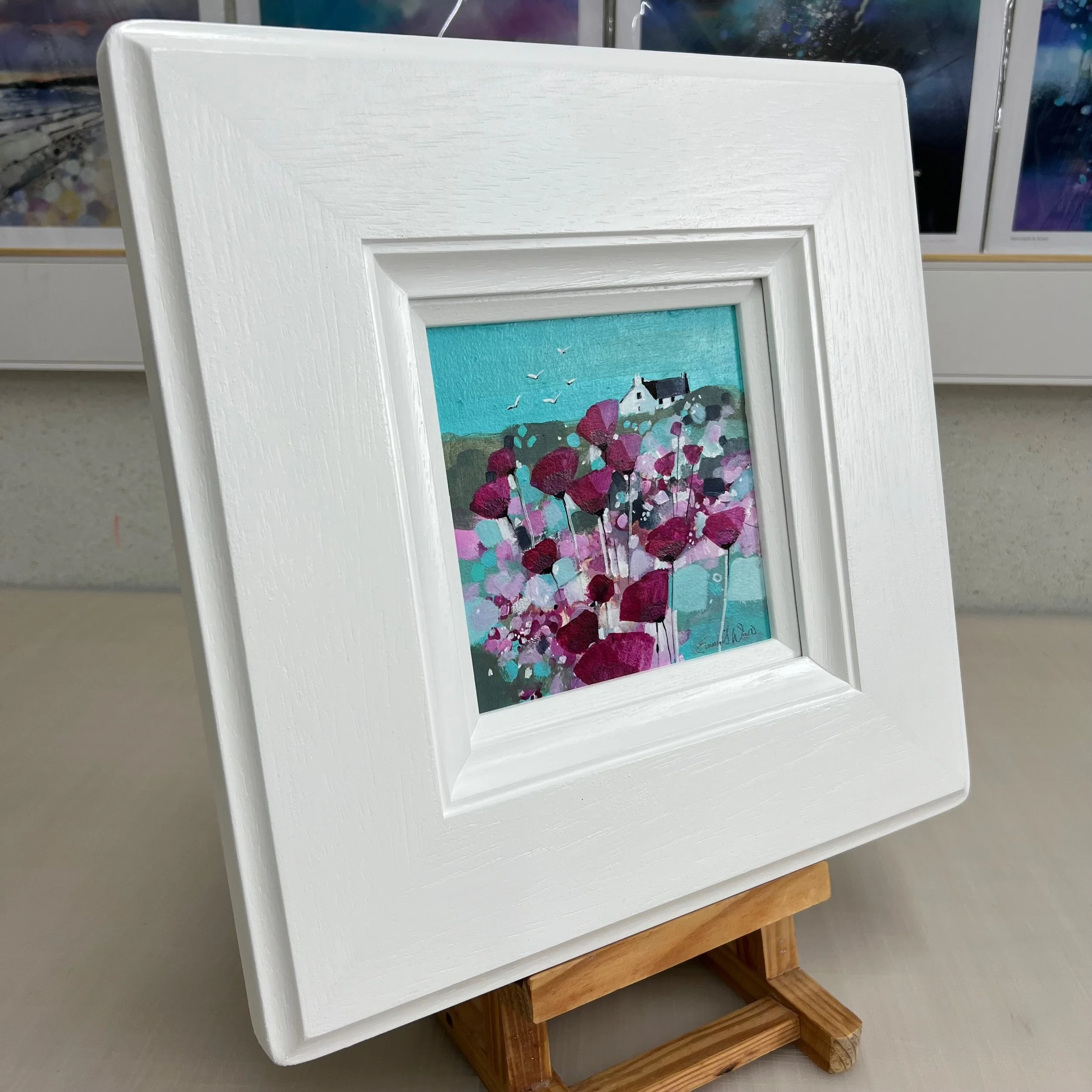 'Together Flying High' - a colourful abstract landscape in this original small oil painting in white frame by Emma S Davis Artist - angled view