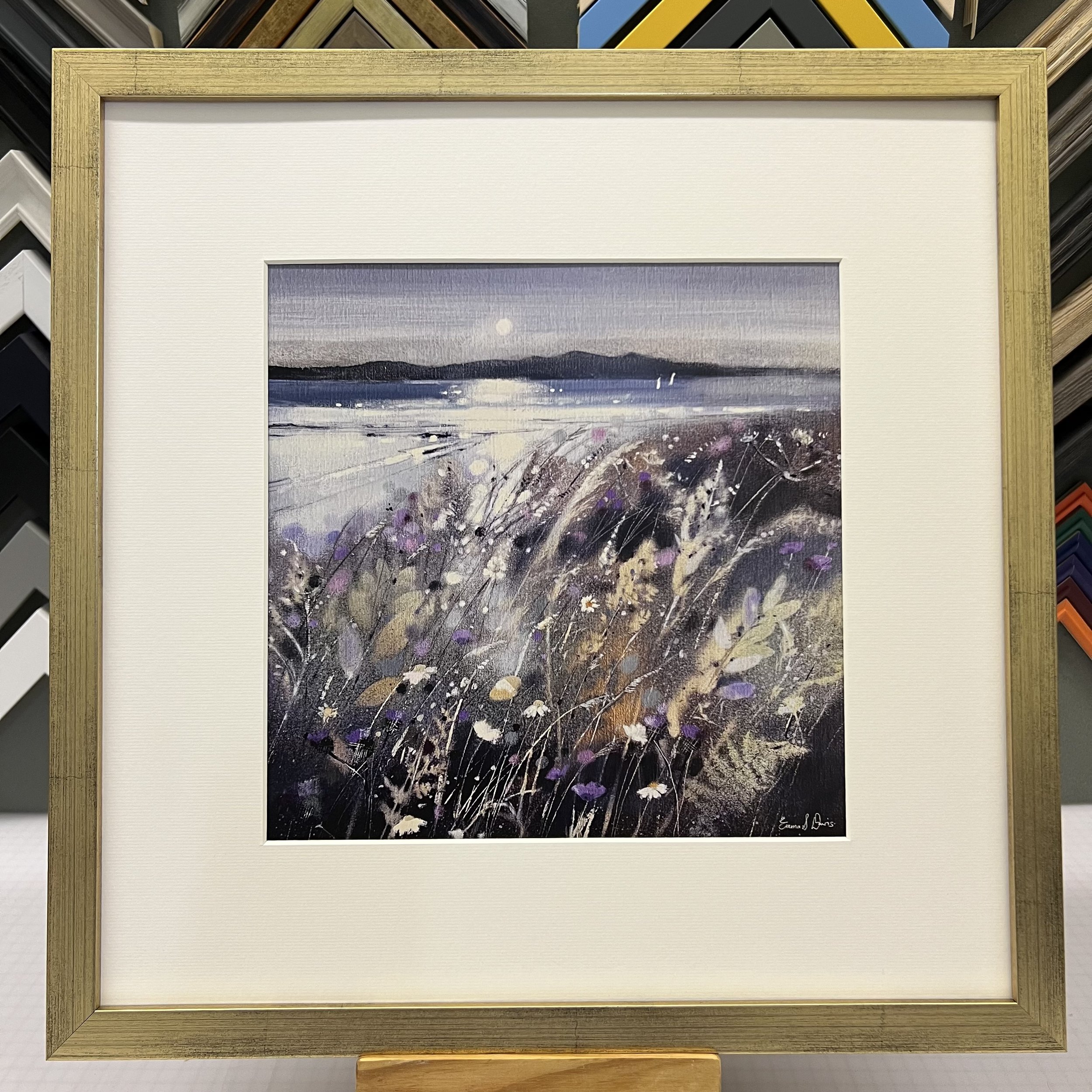 Summer Fields and Arran Open Edition Art Print by Emma S Davis. Presented in a gold frame, showcasing Arran on the horizon and wildflowers dancing in the summer breeze.
