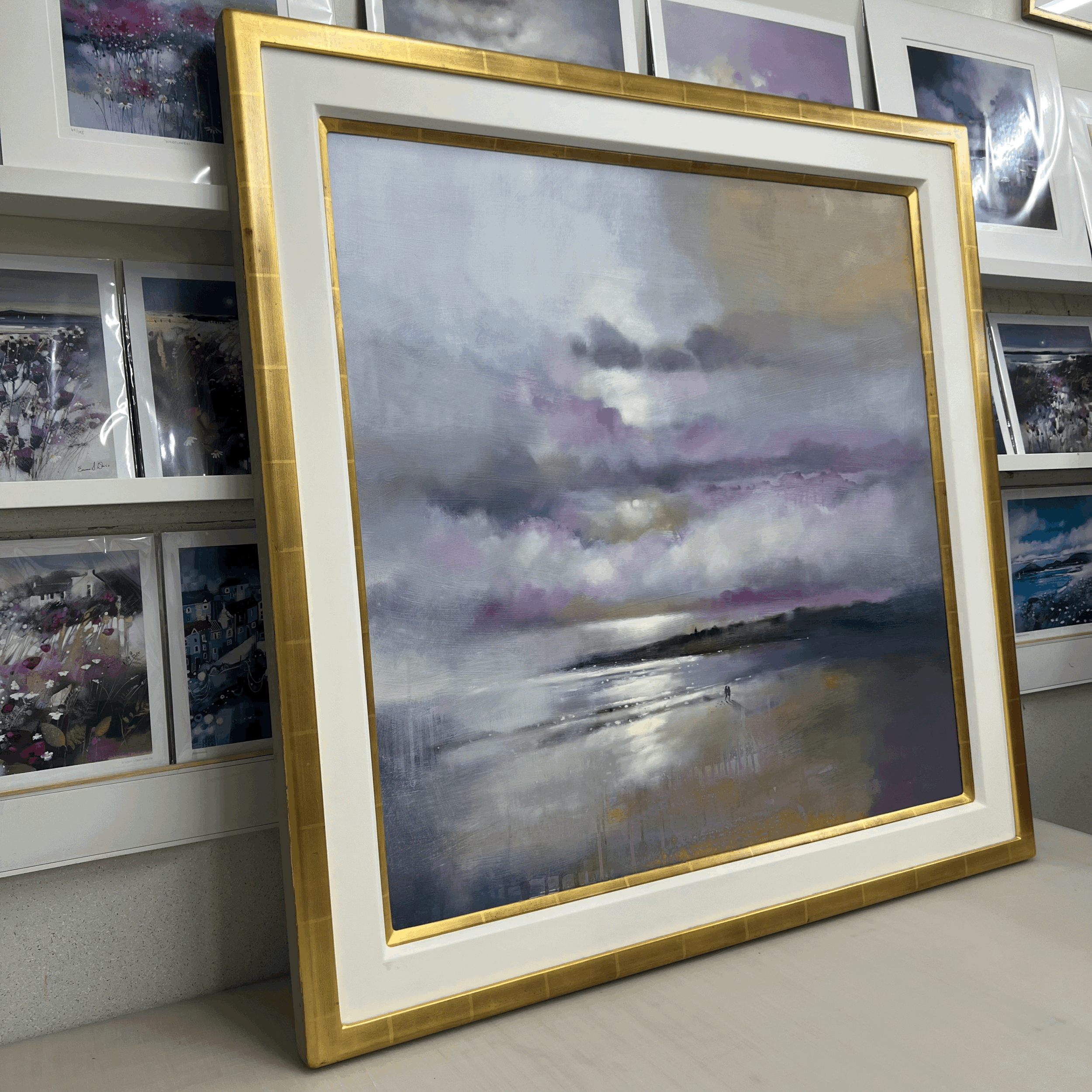 Together, St Andrews by Emma S Davis original oil painting featuring two figures walking along the shoreline beneath dramatic skies. Side  view.