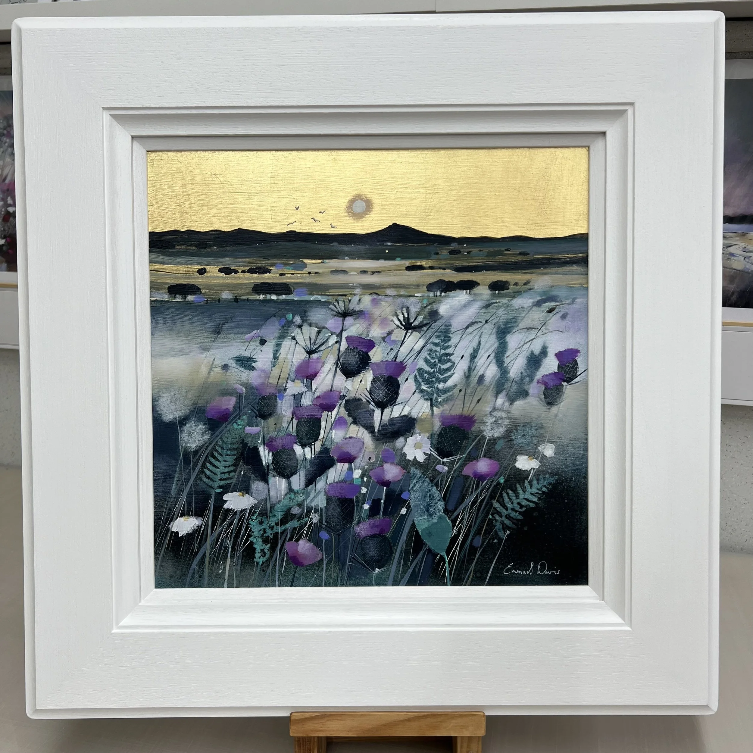 Bennachie at Moonlight original oil and gold leaf painting by Scottish artist Emma S Davis featuring Bennachie with wildflowers beneath a golden moonlit sky. Framed view.