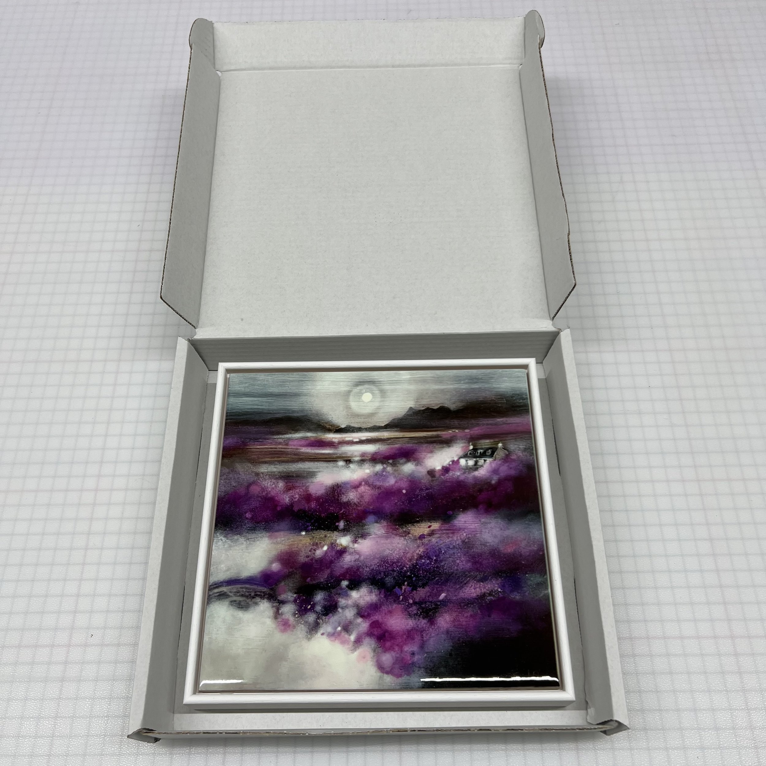 Isle of Skye Heather Scottish landscape framed ceramic tile featuring purple heather inspired by the Isle of Skye by Emma S Davis Artist. Packaging.